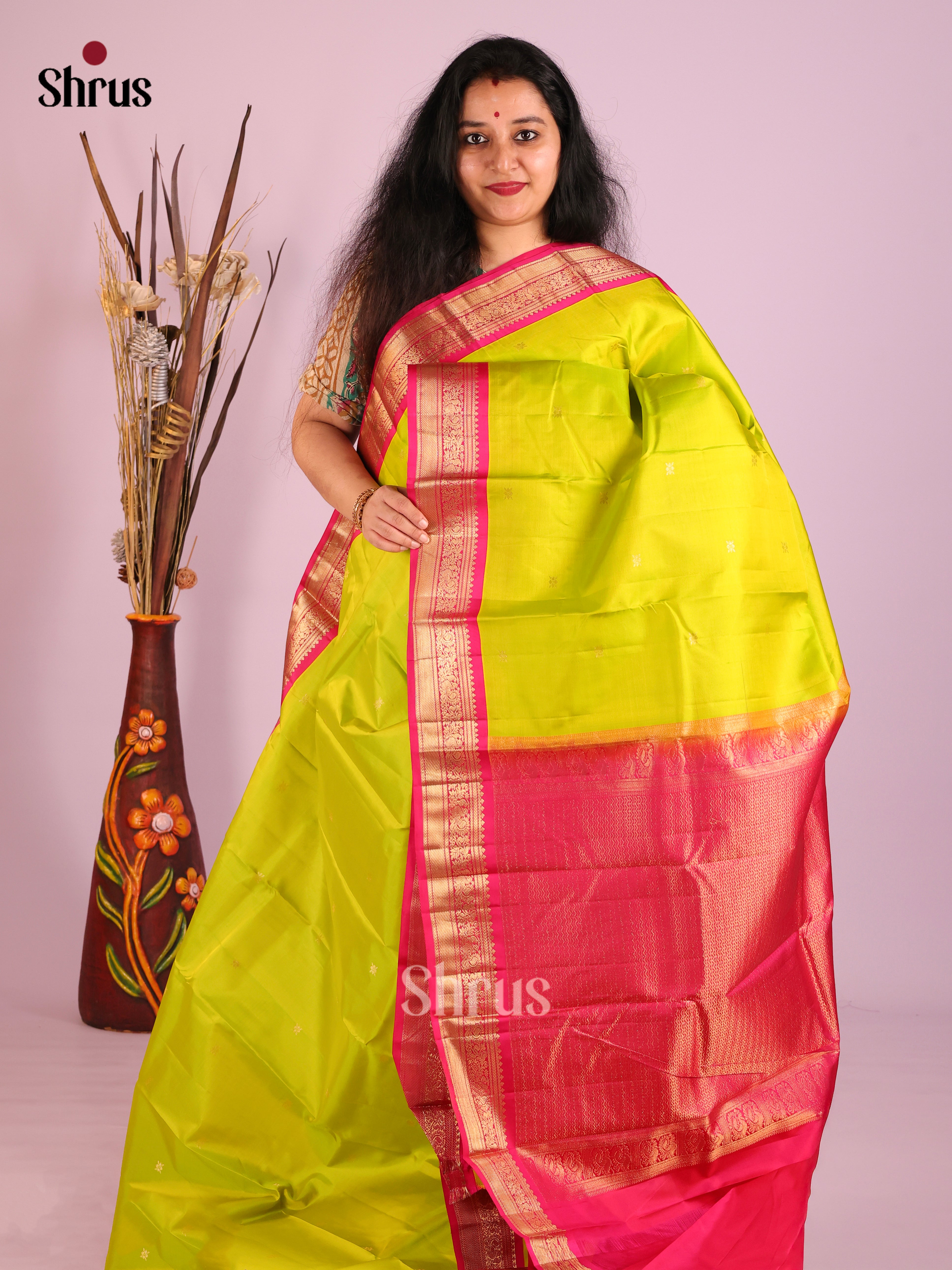 Exquisite Lime Green Kanjivaram Saree with Buttas & Pink peacock vines zari border