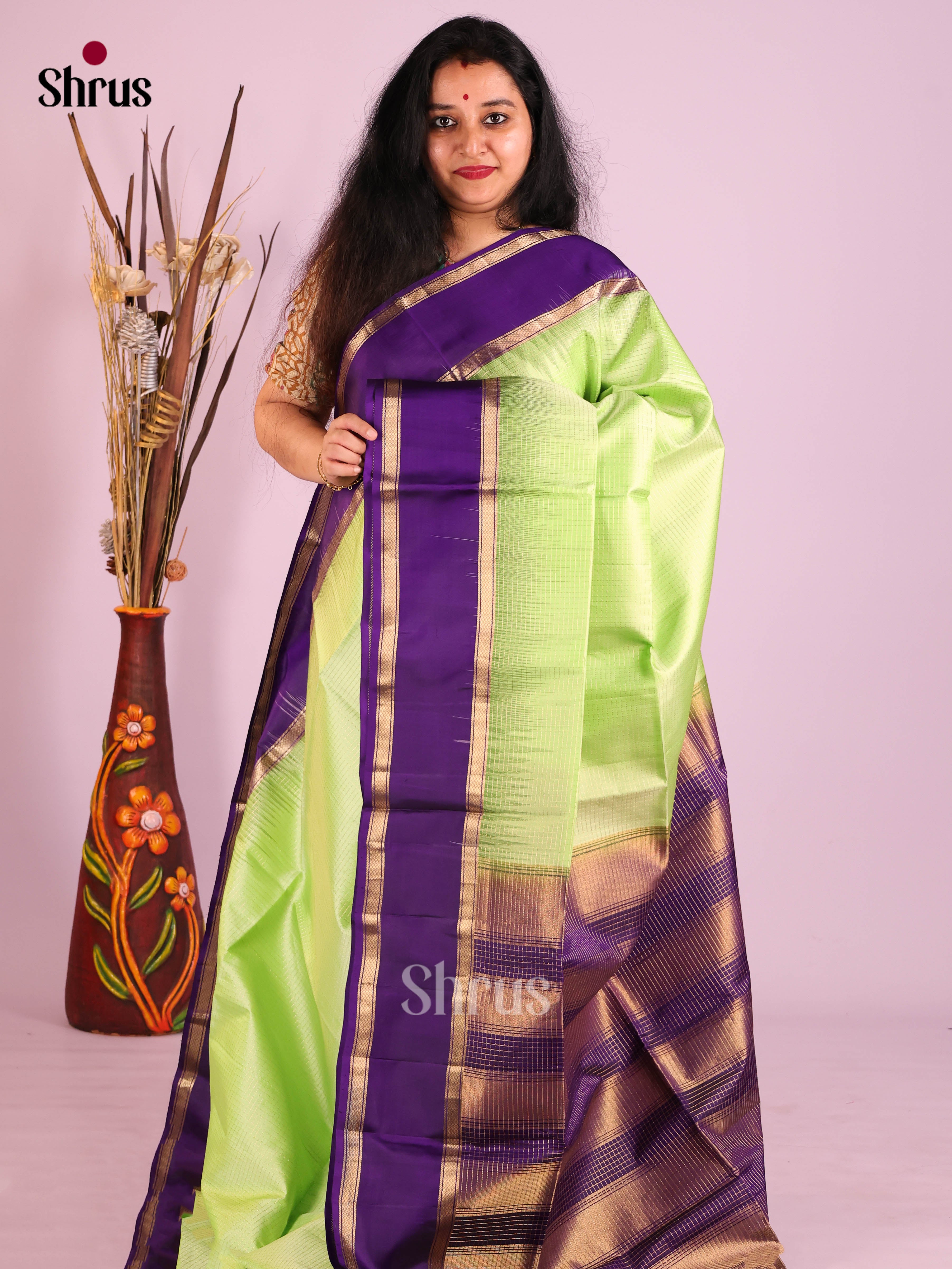 Graceful Pista Green Soft Silk Saree with zari checks & Violet rettaipet zari border