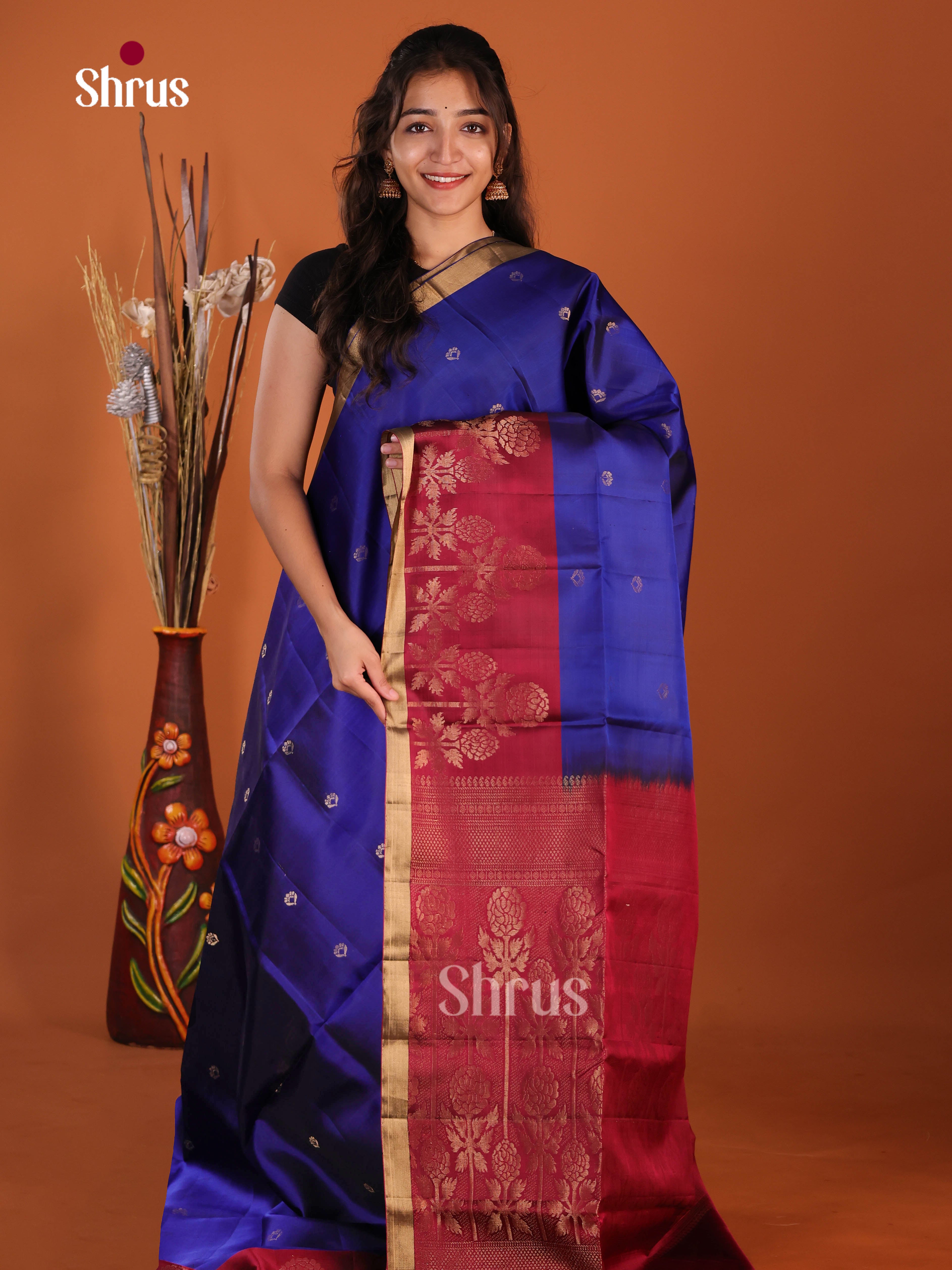 Vibrant Blue & Maroon Soft Silk Saree gleams with gold zari floral buttas