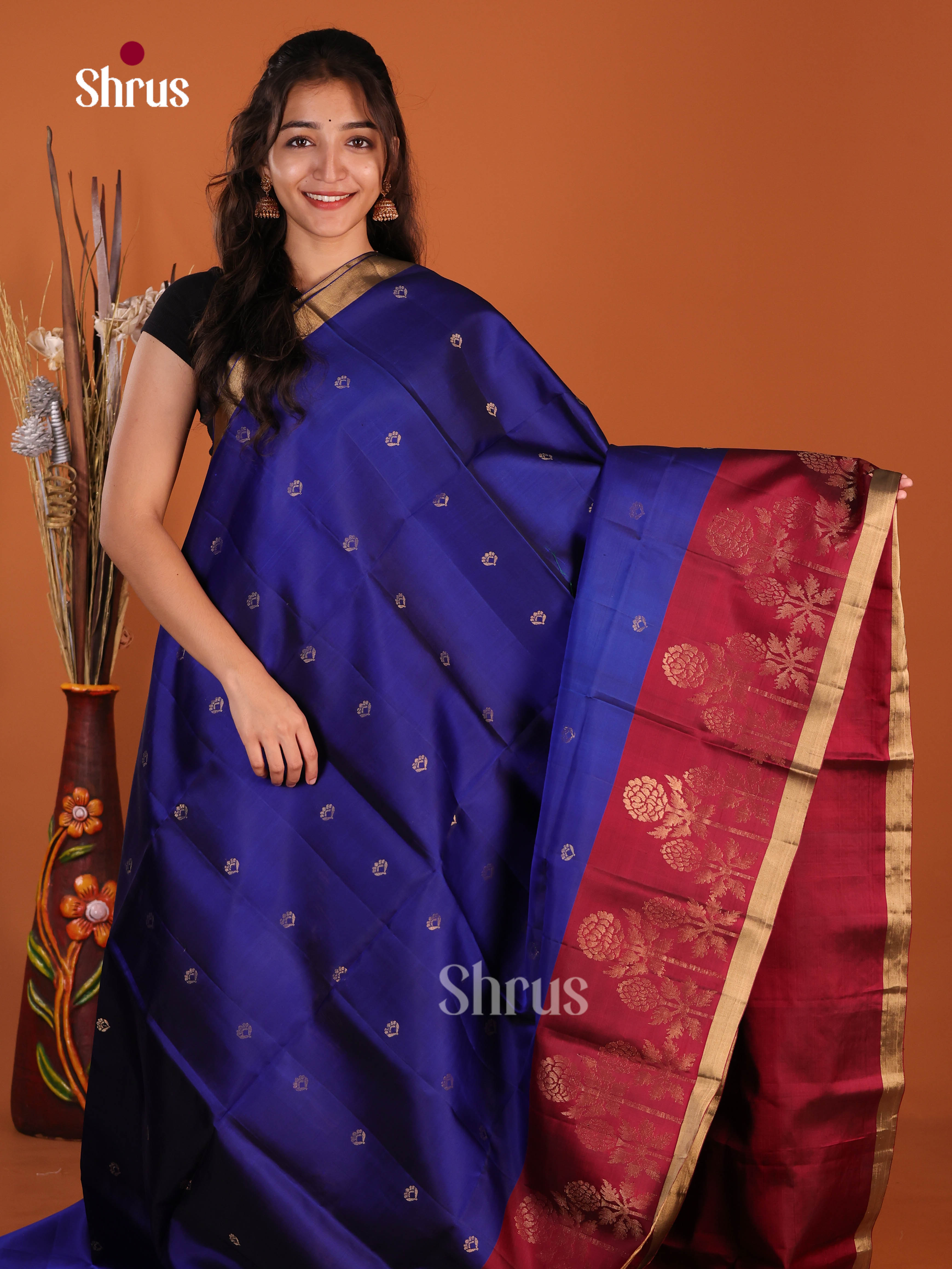 Vibrant Blue & Maroon Soft Silk Saree gleams with gold zari floral buttas