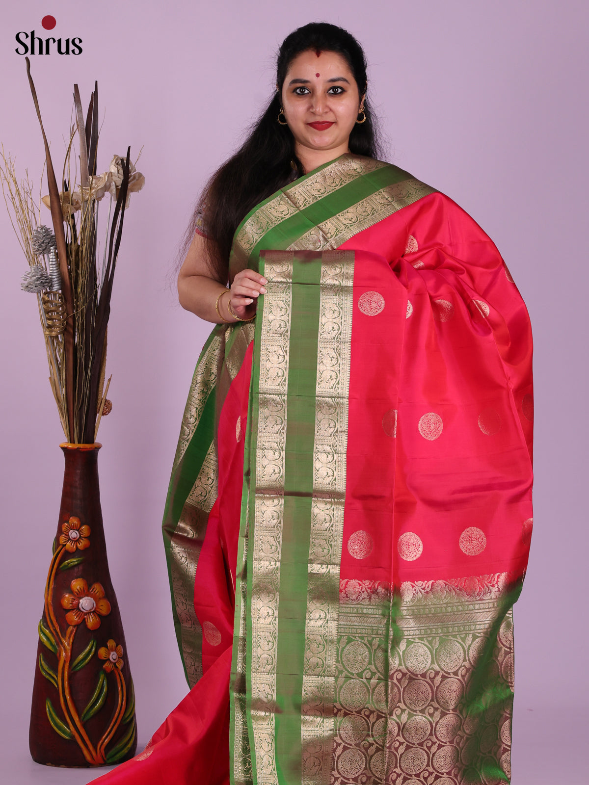 Chic Red & Green Soft Silk Saree gleams with zari floral motifs , rettaipet border