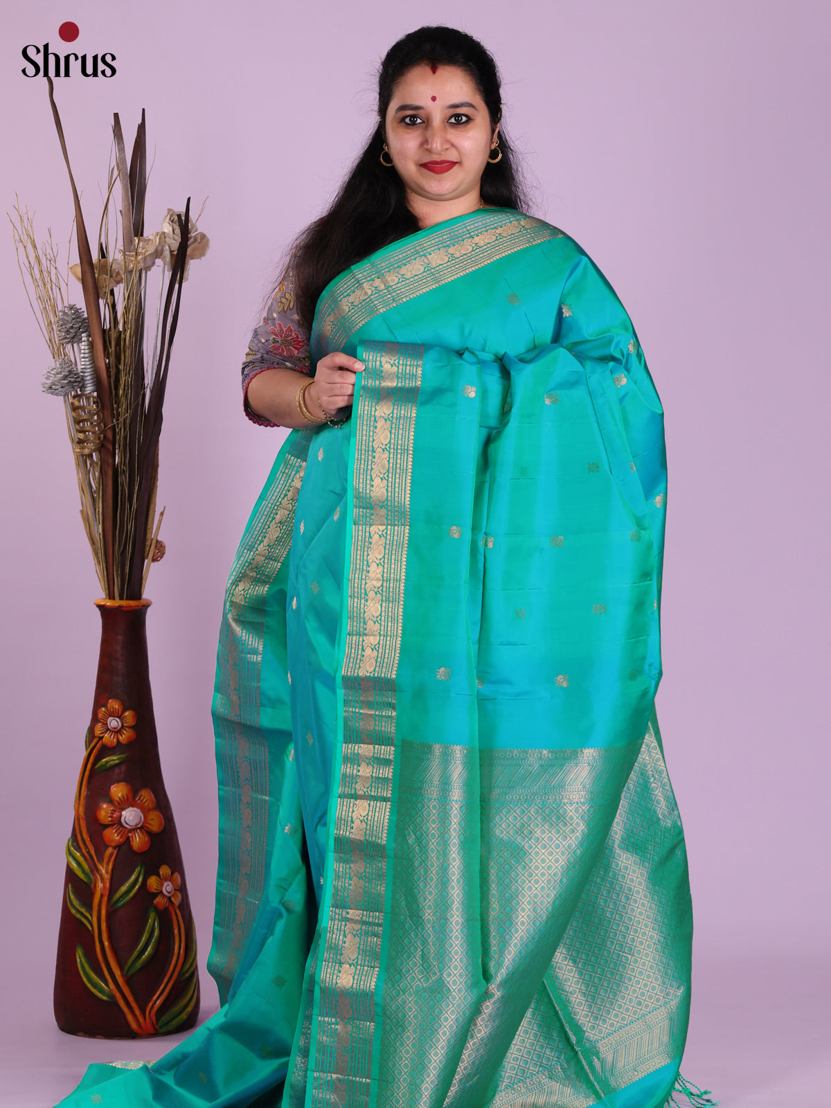 Vibrant Teal Soft Silk Saree with gold peacock buttas & Zari Woven Border