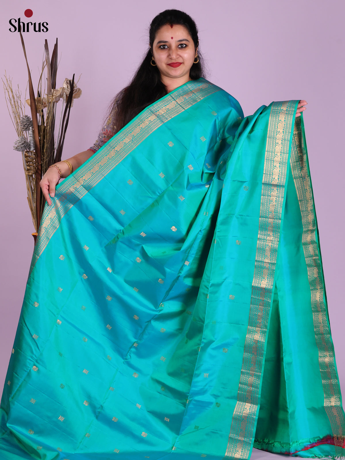 Vibrant Teal Soft Silk Saree with gold peacock buttas & Zari Woven Border