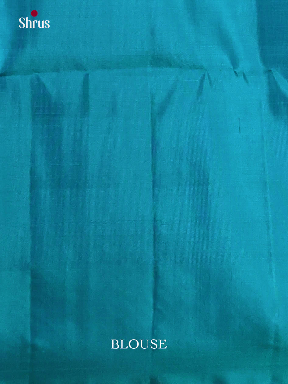 Lustrous Pista green Soft Silk Saree gleams with zari woven floral nestling brocade