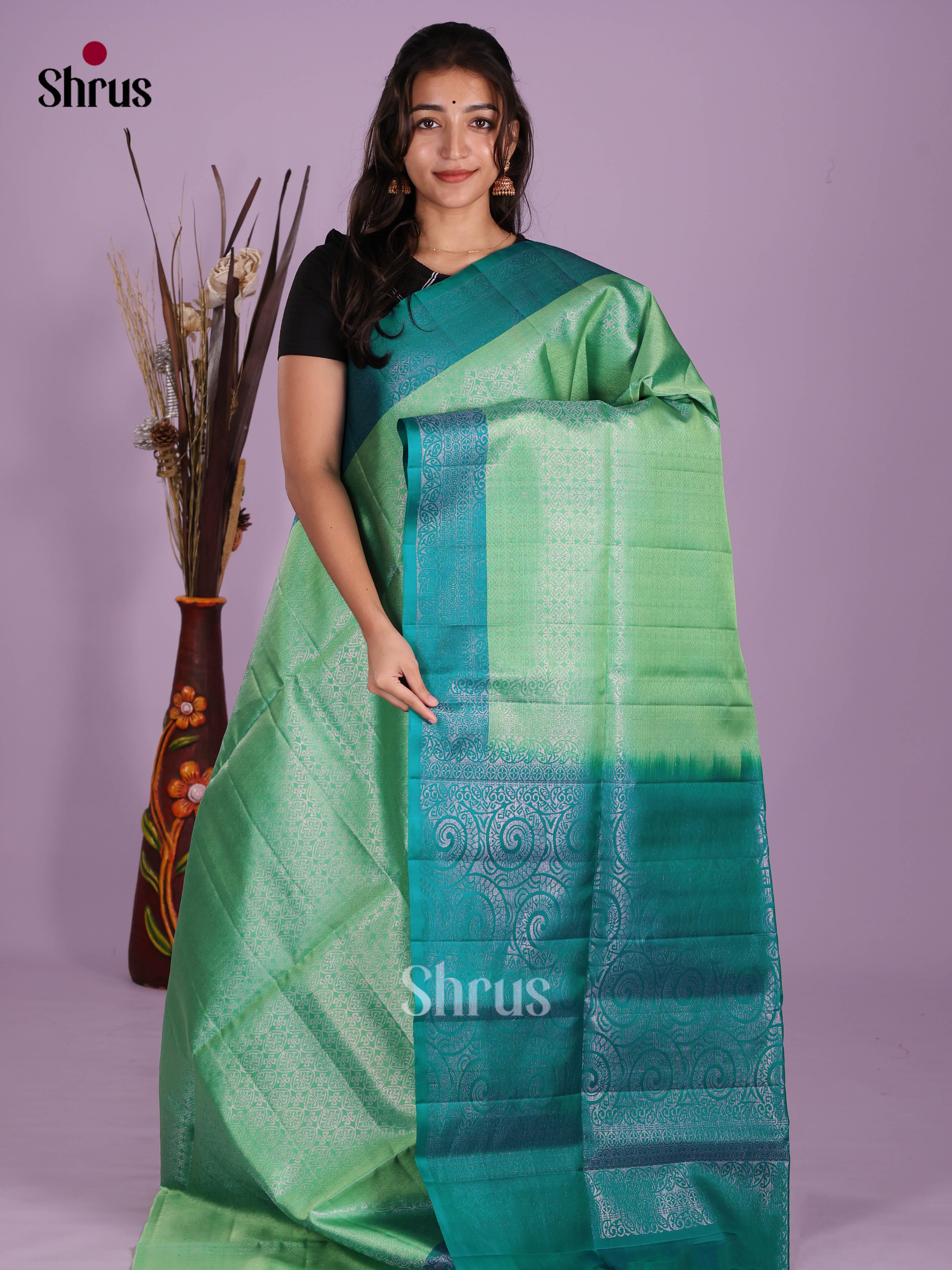 Elegant Pista Green & Green Soft Silk Saree dazzles with zari floral nestling brocade