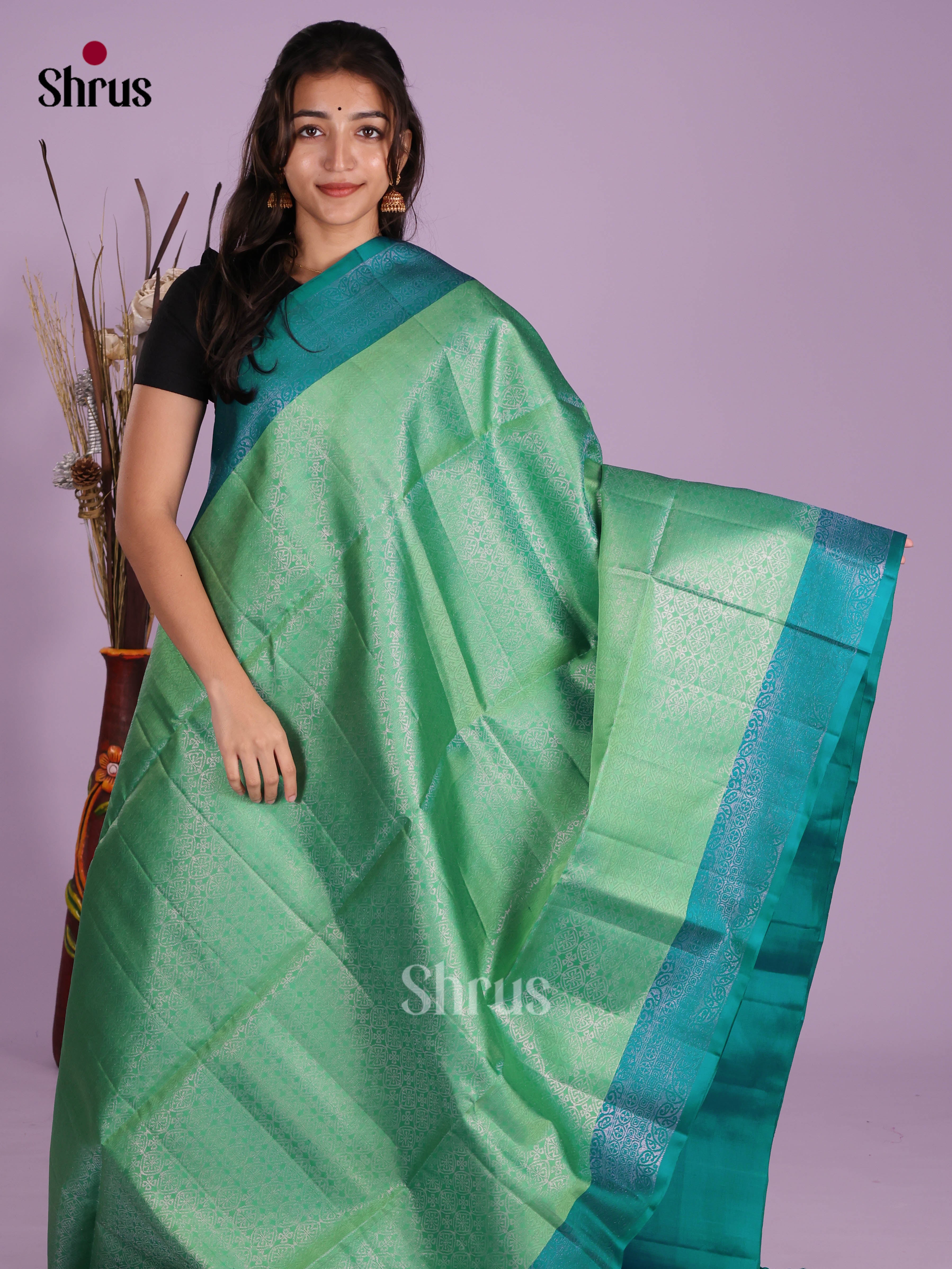 Elegant Pista Green & Green Soft Silk Saree dazzles with zari floral nestling brocade