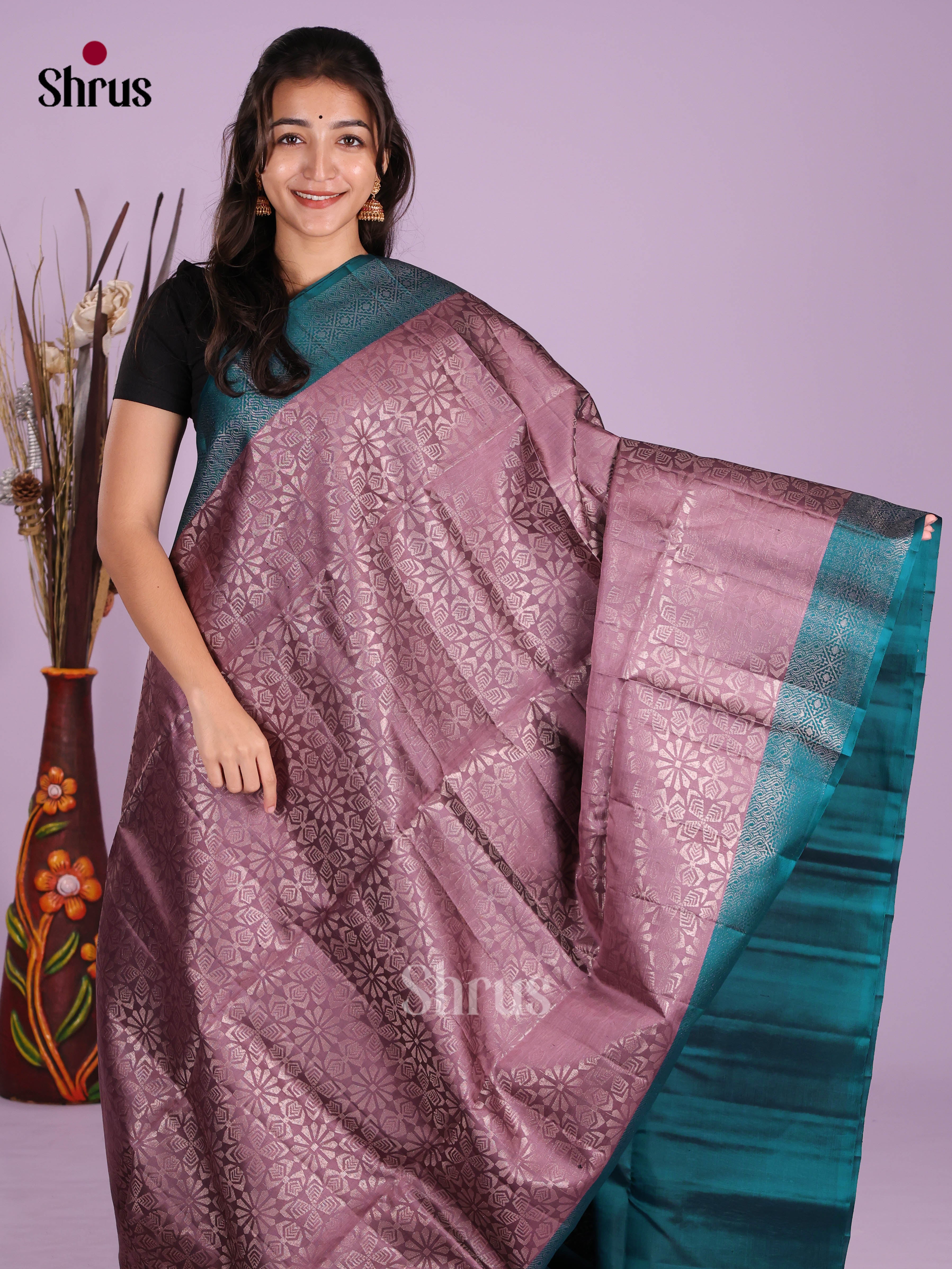 Regal Mauve & Blue Soft Silk Saree gleams with zari floral brocade