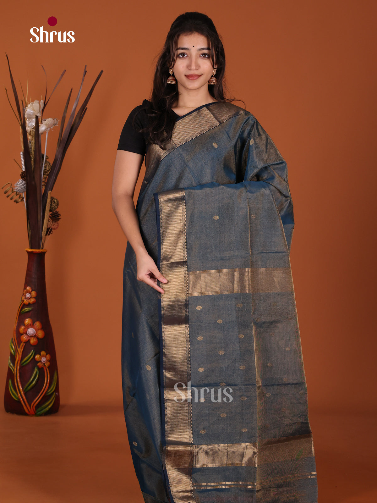 Shimmery Blue Maheshwari silkcotton Saree gleams with zari buttas