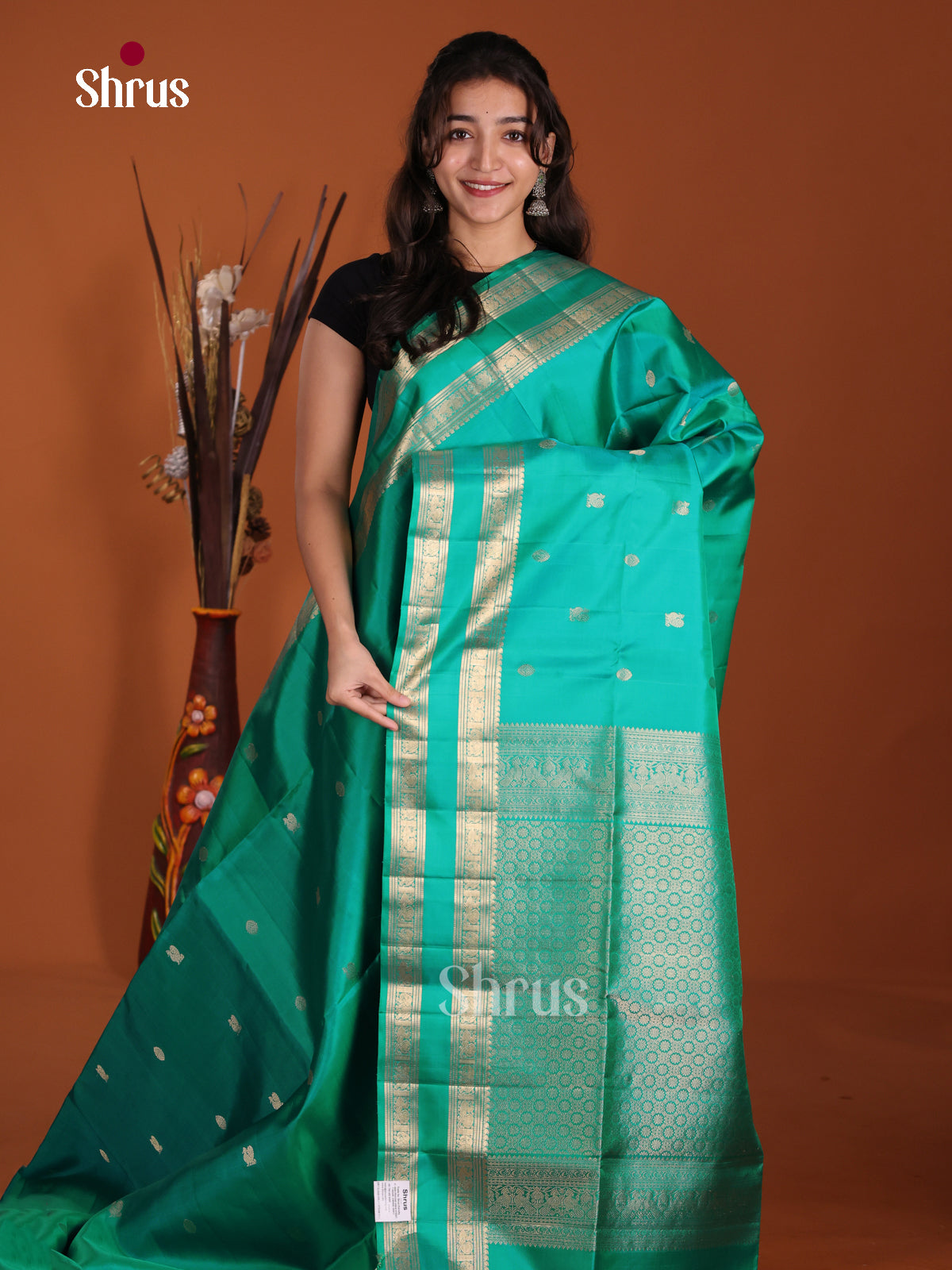 Pretty Teal single Tone Soft Silk Saree gleams with zari peacock buttas