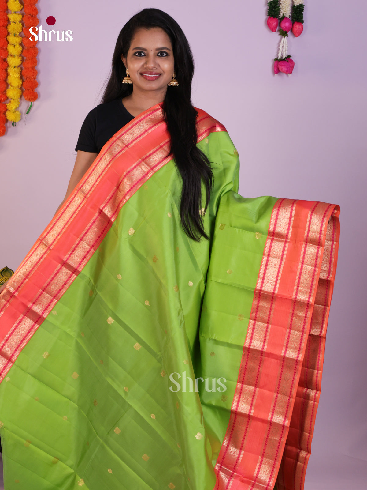 Green Kanchipuram Saree with Zari Buttas & Coral Rettaipet Border