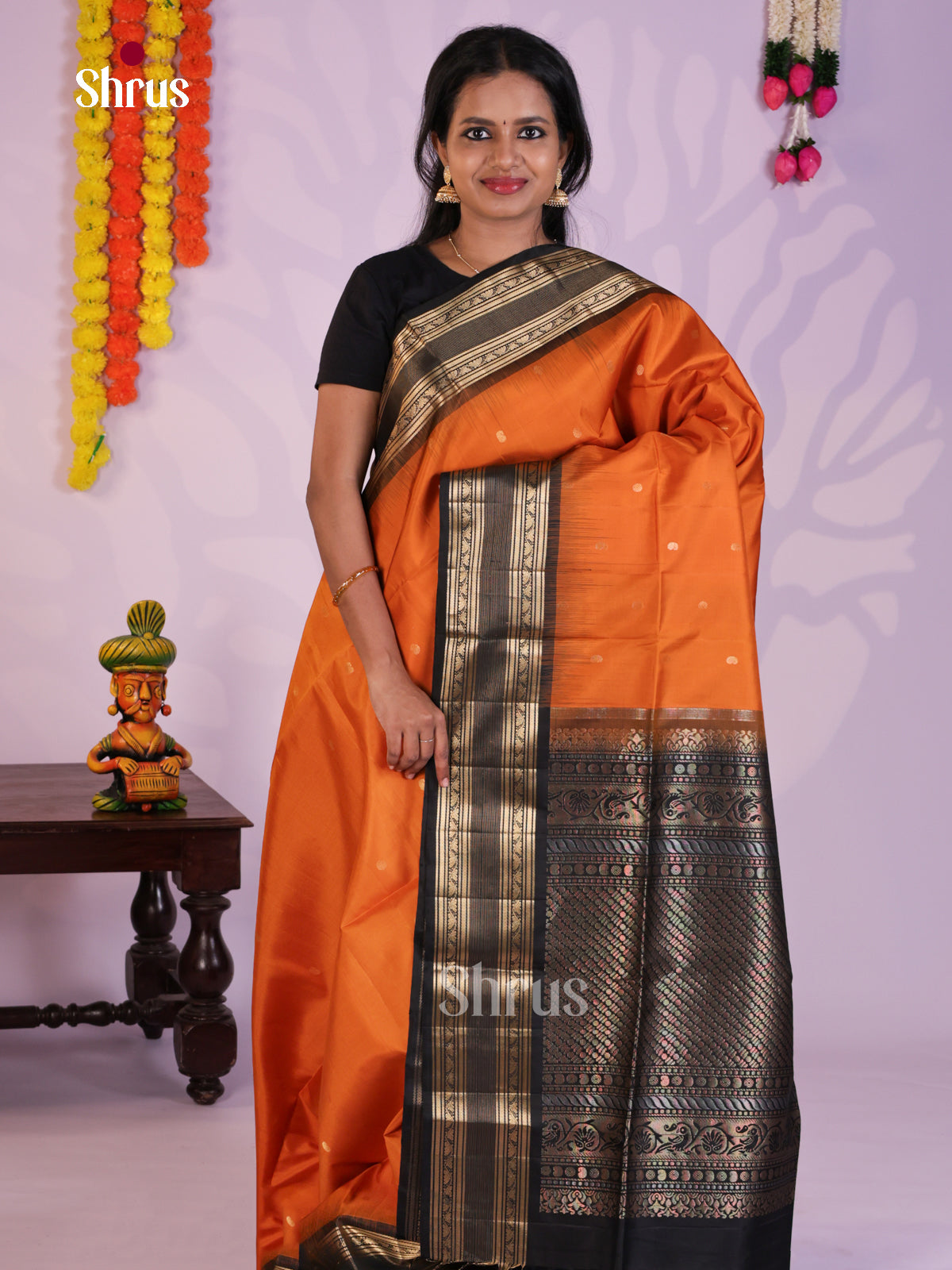 Radiant Orange Soft Silk Saree gleams with zari buttas & Rettaipet border