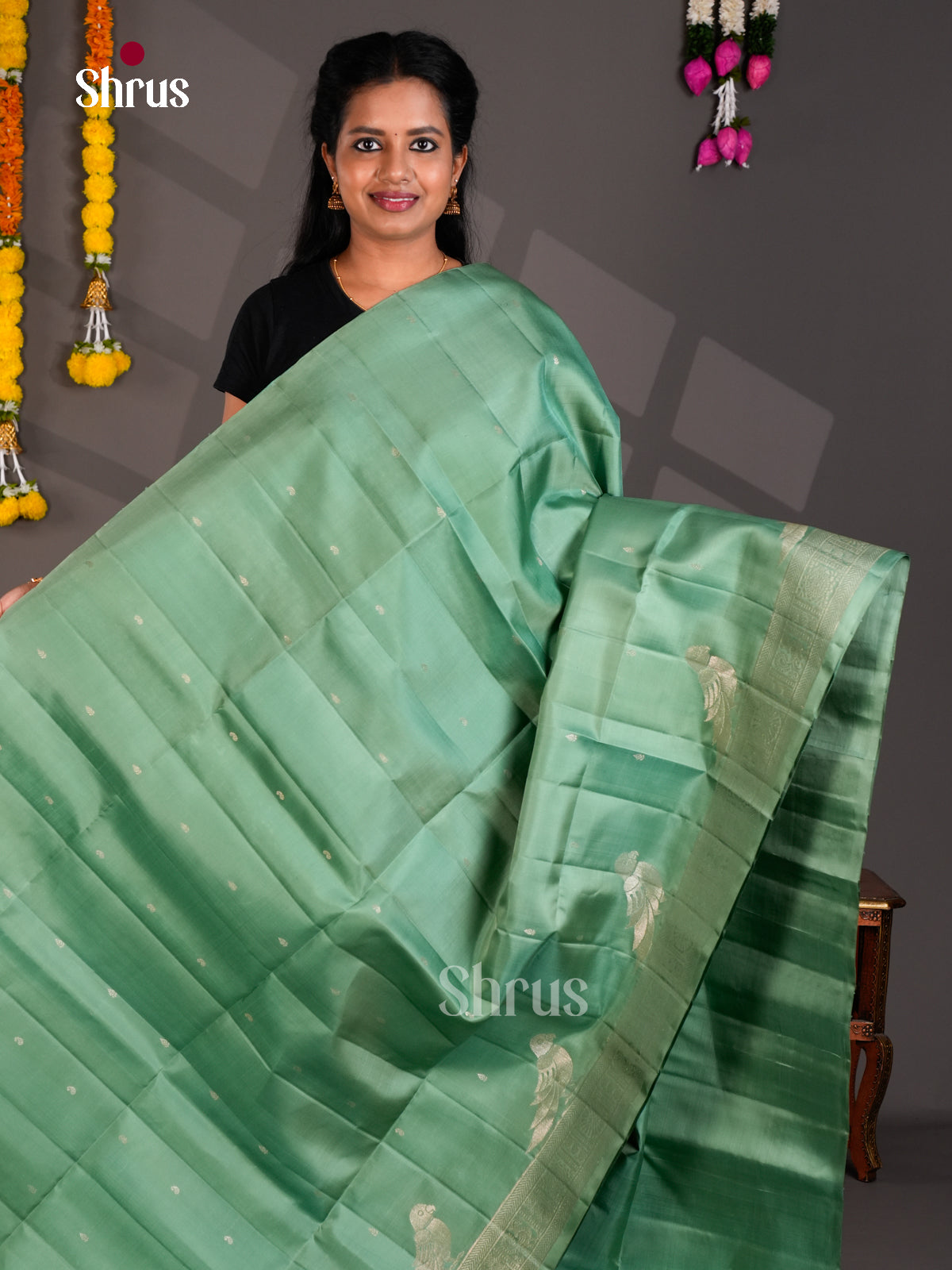 Model is wearing Seafoam Green Pure Soft Silk Saree with Silver Buttas & Bird Motifs Woven Pallu