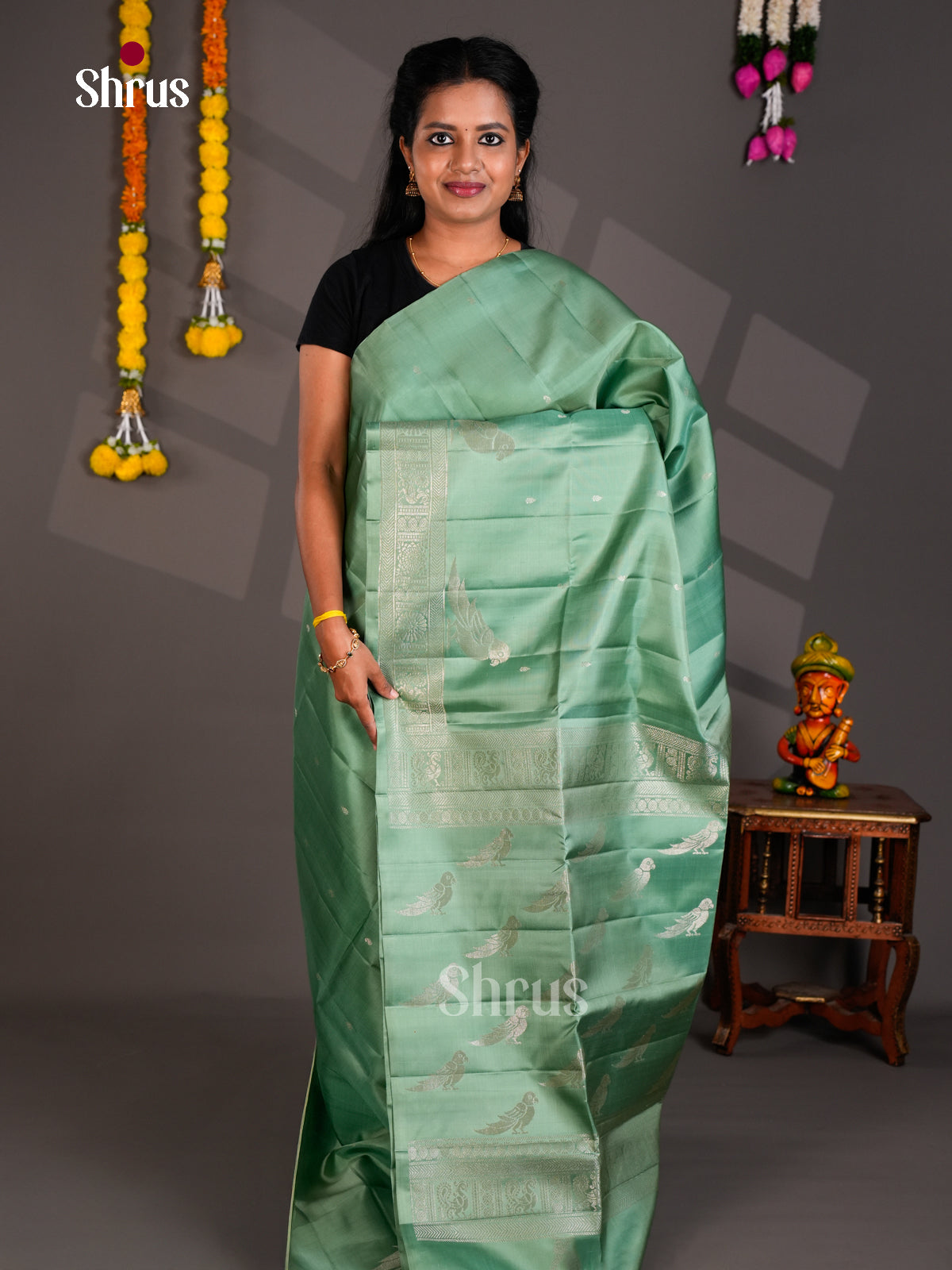 Model is wearing Seafoam Green Soft Silk Saree with Silver Buttas & Bird Motifs Woven Pallu