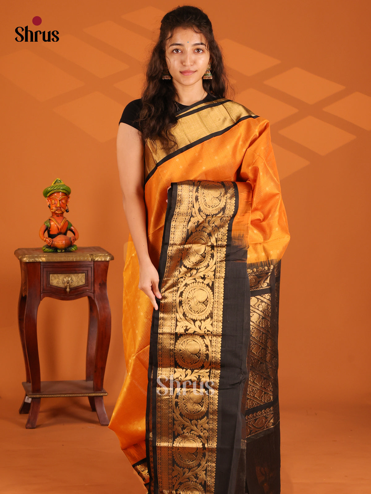 Shimmery Mustard Silk Cotton Saree with zari woven peacock motifs in Black Border