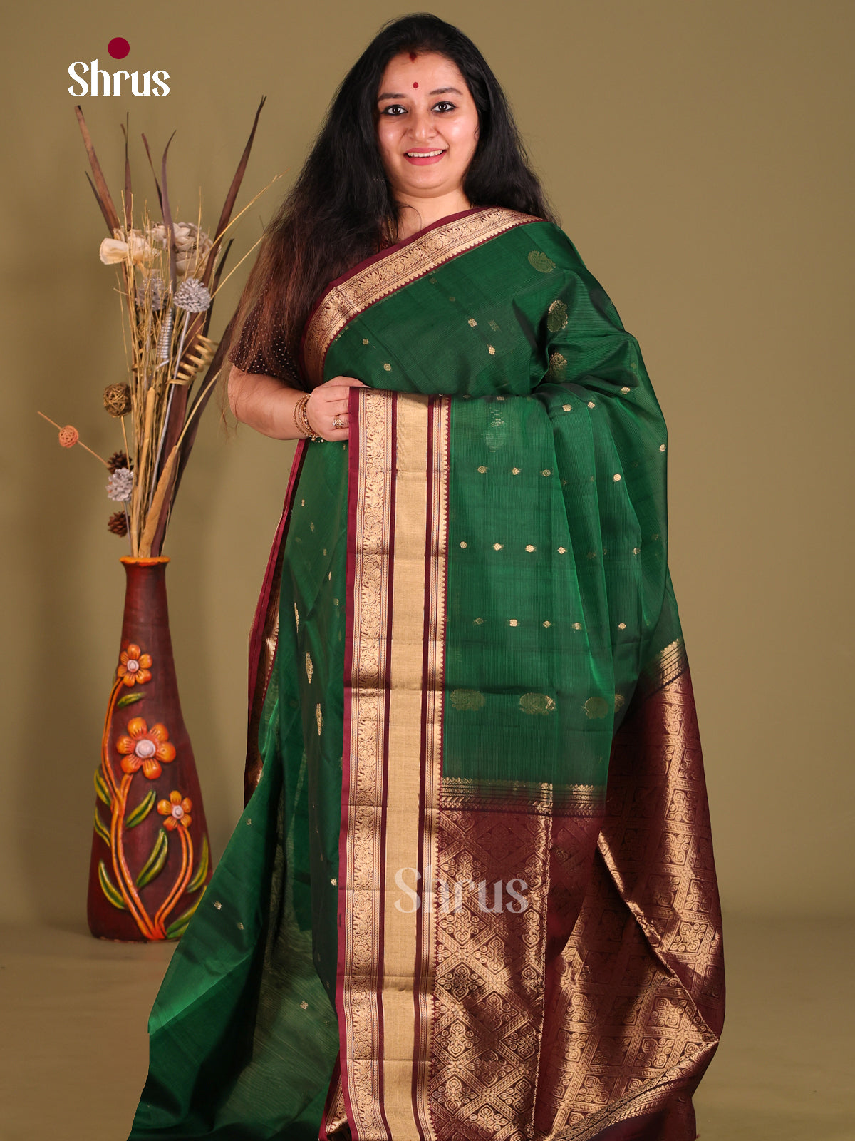 Green & Maroon Silk Cotton Saree gleams with gold zari peacock buttas - Shop on Shrus.com