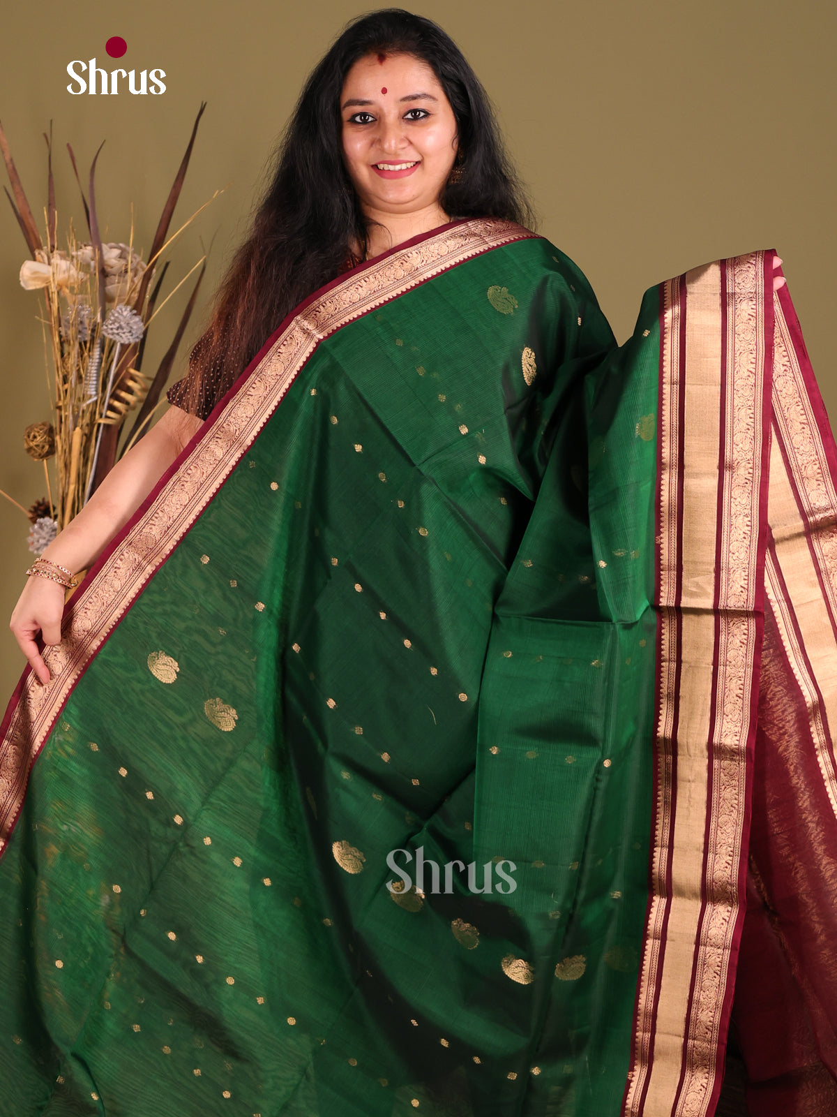 Green & Maroon Silk Cotton Saree gleams with gold zari peacock buttas - Shop on Shrus.com
