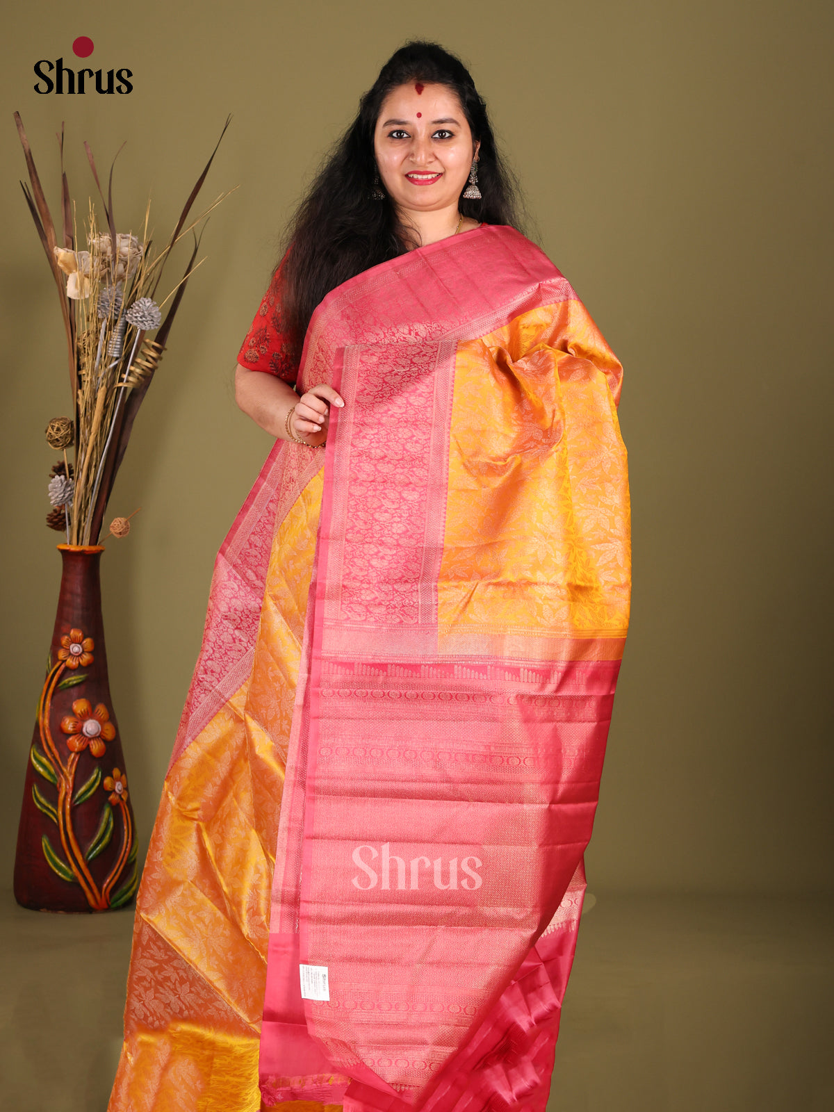 Luminous Orange Kanchipuram silk Saree with floral nestling brocade & Pink Zari Border 