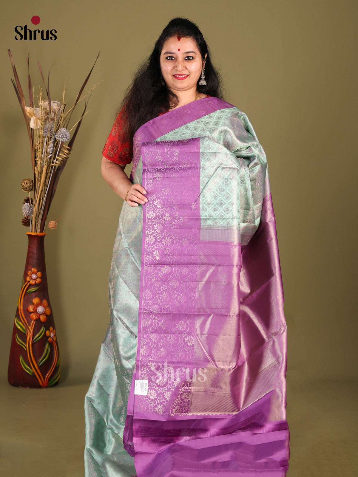 Exquisite Pastel Green Kanjivaram silk Saree with floral brocade body & Purple Border 