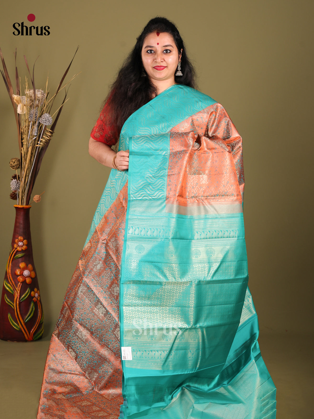 Exquisite Rust Orange Kanjivaram silk Saree with floral Nestling brocade & Sky Blue Border