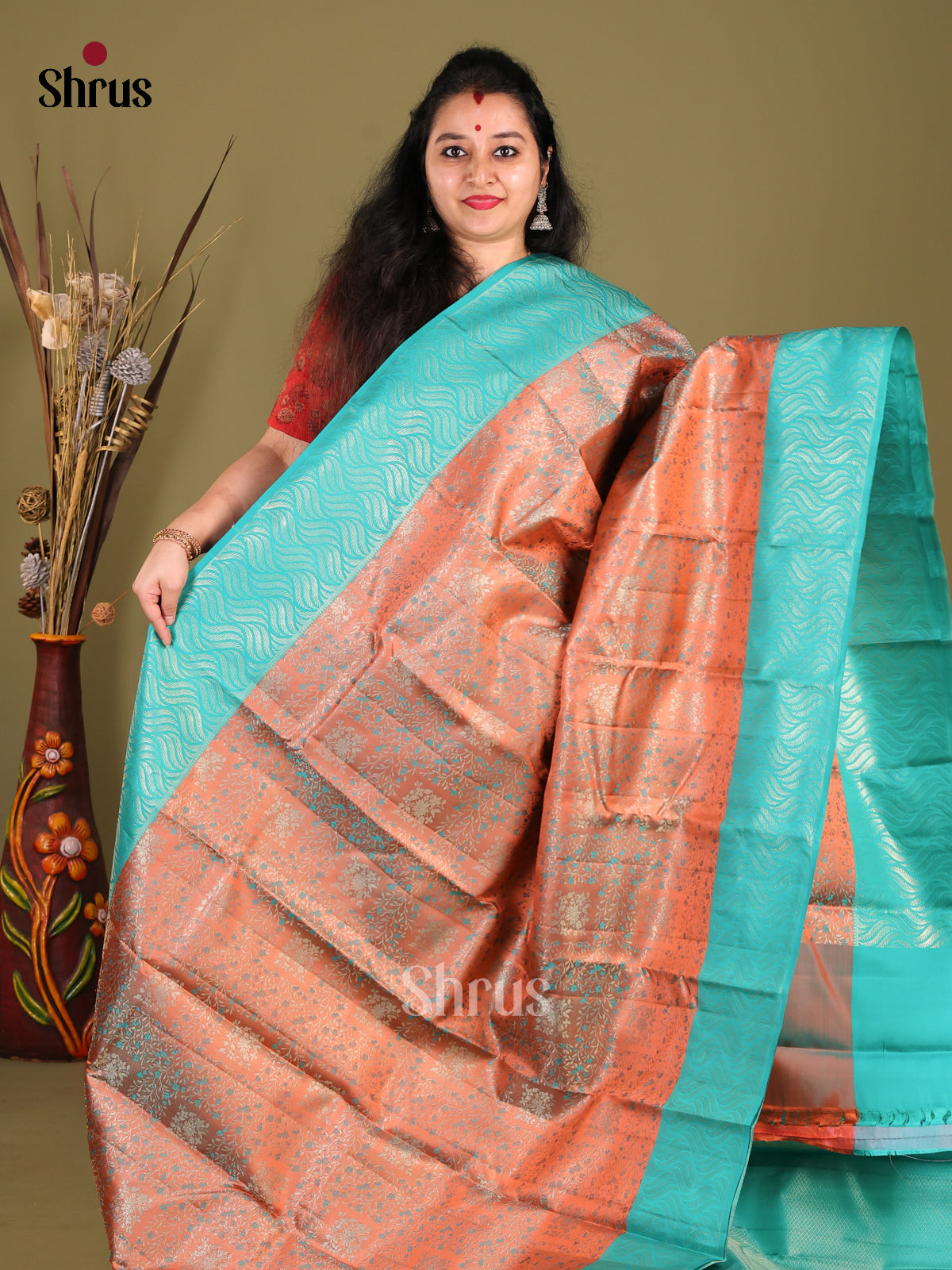 Exquisite Rust Orange Kanjivaram silk Saree with floral Nestling brocade & Sky Blue Border