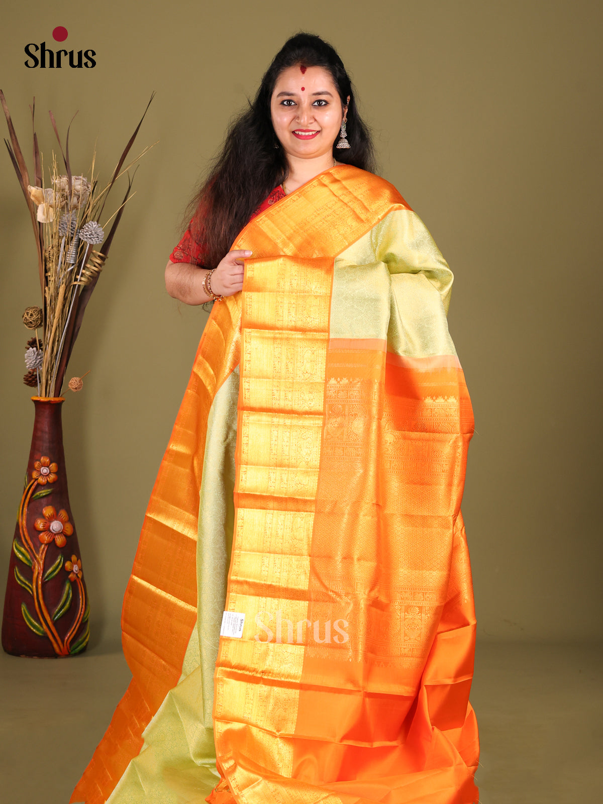 Lustrous Light Green Kanjivaram silk Saree with rich Zari Brocade & Grand Orange border
