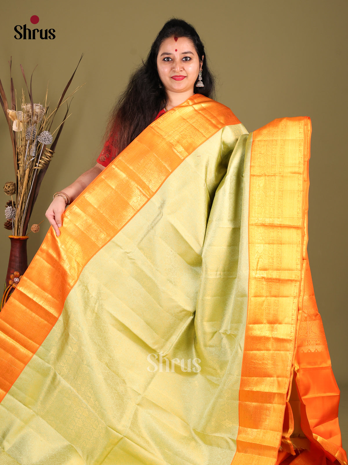 Lustrous Light Green Kanjivaram silk Saree with rich Zari Brocade & Grand Orange border 