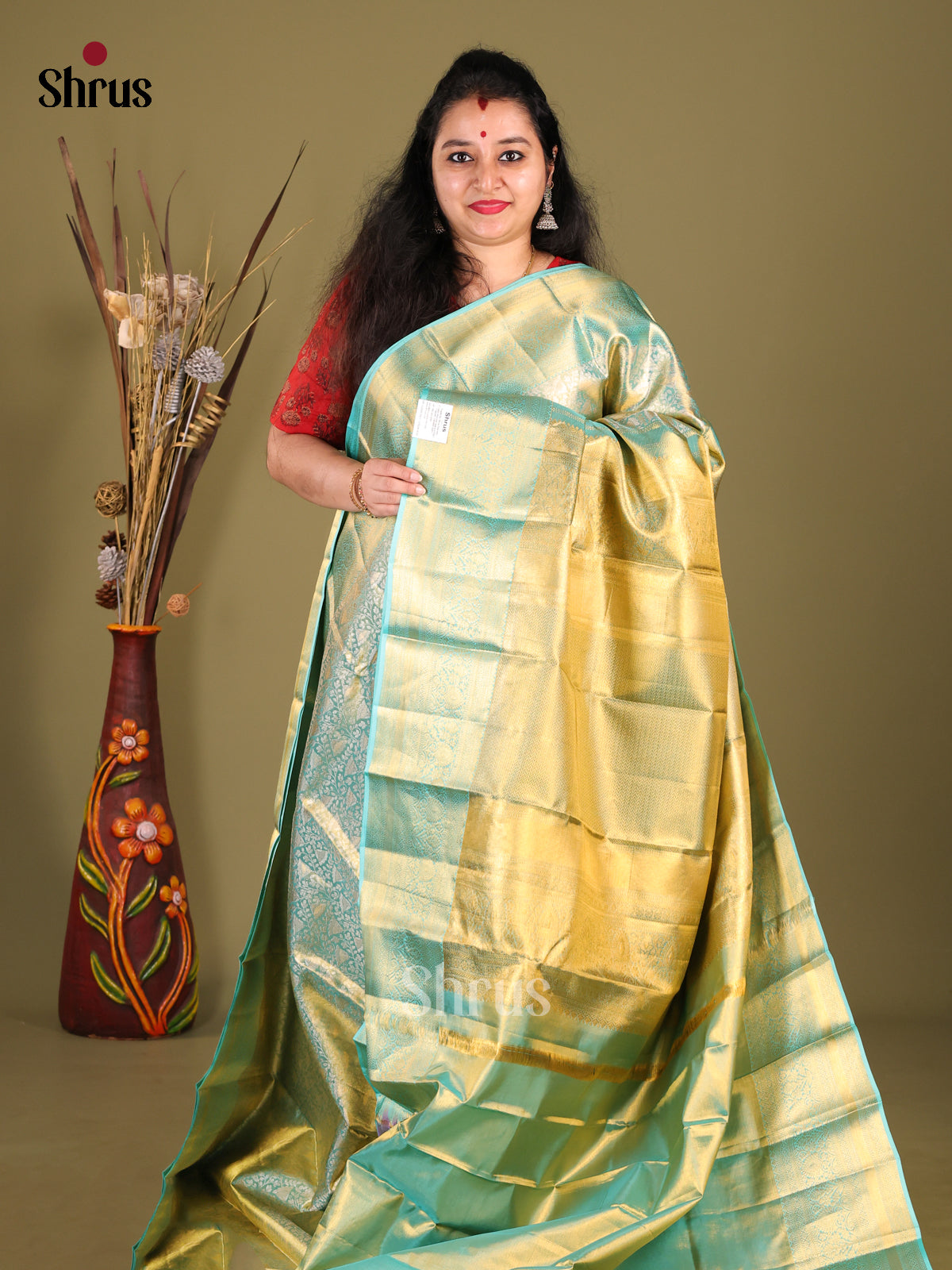 Chic Teal blue Kanjivaram silk Saree with floral nestling brocade & Zari Border