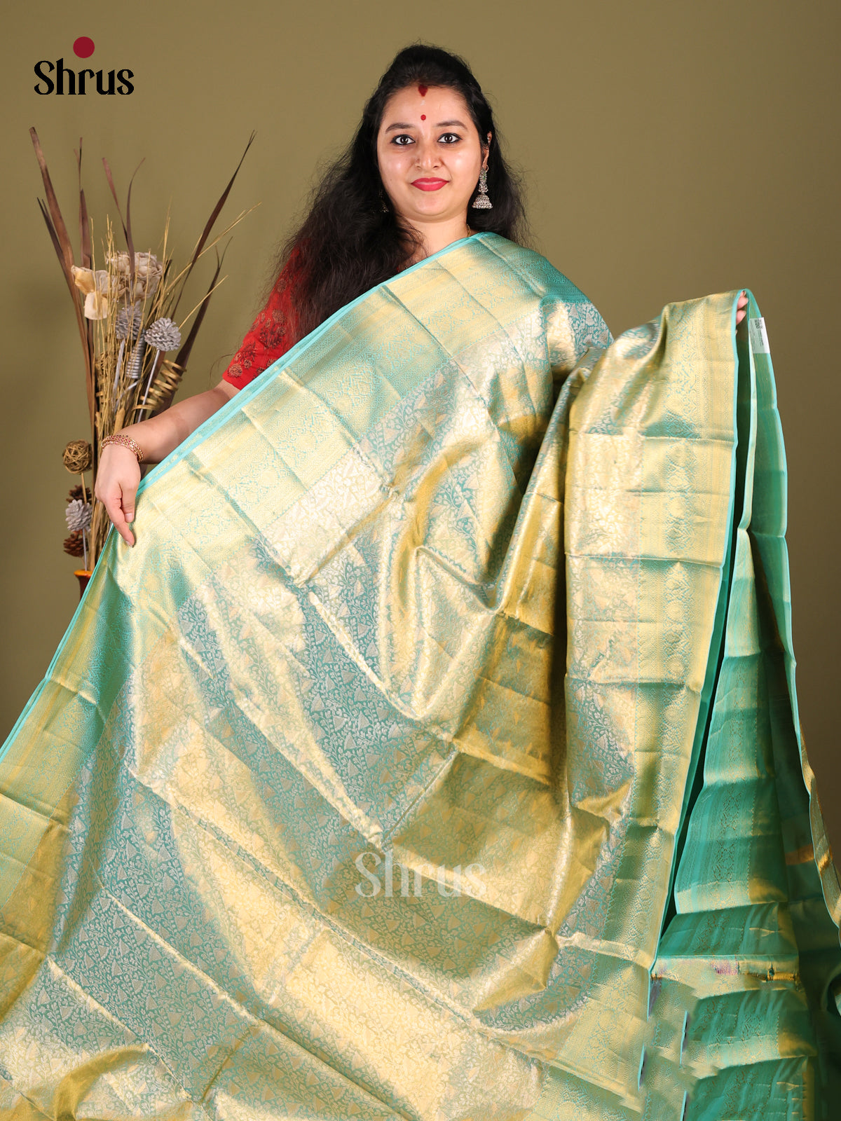 Chic Teal blue Kanjivaram silk Saree with floral nestling brocade & Zari Border