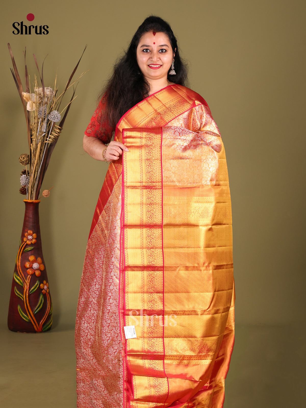 Stunning Orange Kanchipuram silk Saree with floral nestling brocade & Red Zari Border 