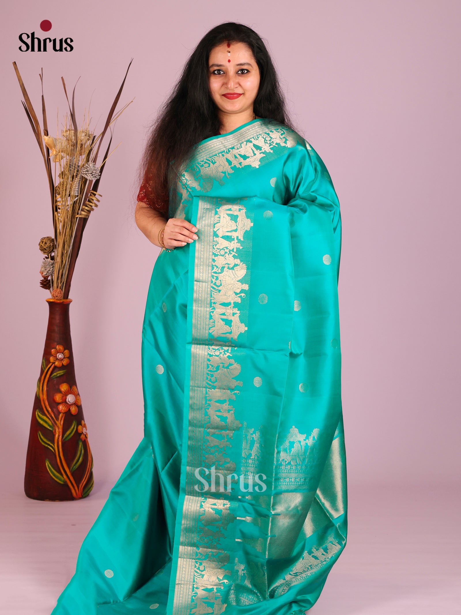Exquisite Teal Soft Silk Saree with Zari Buttas & baraat themed border