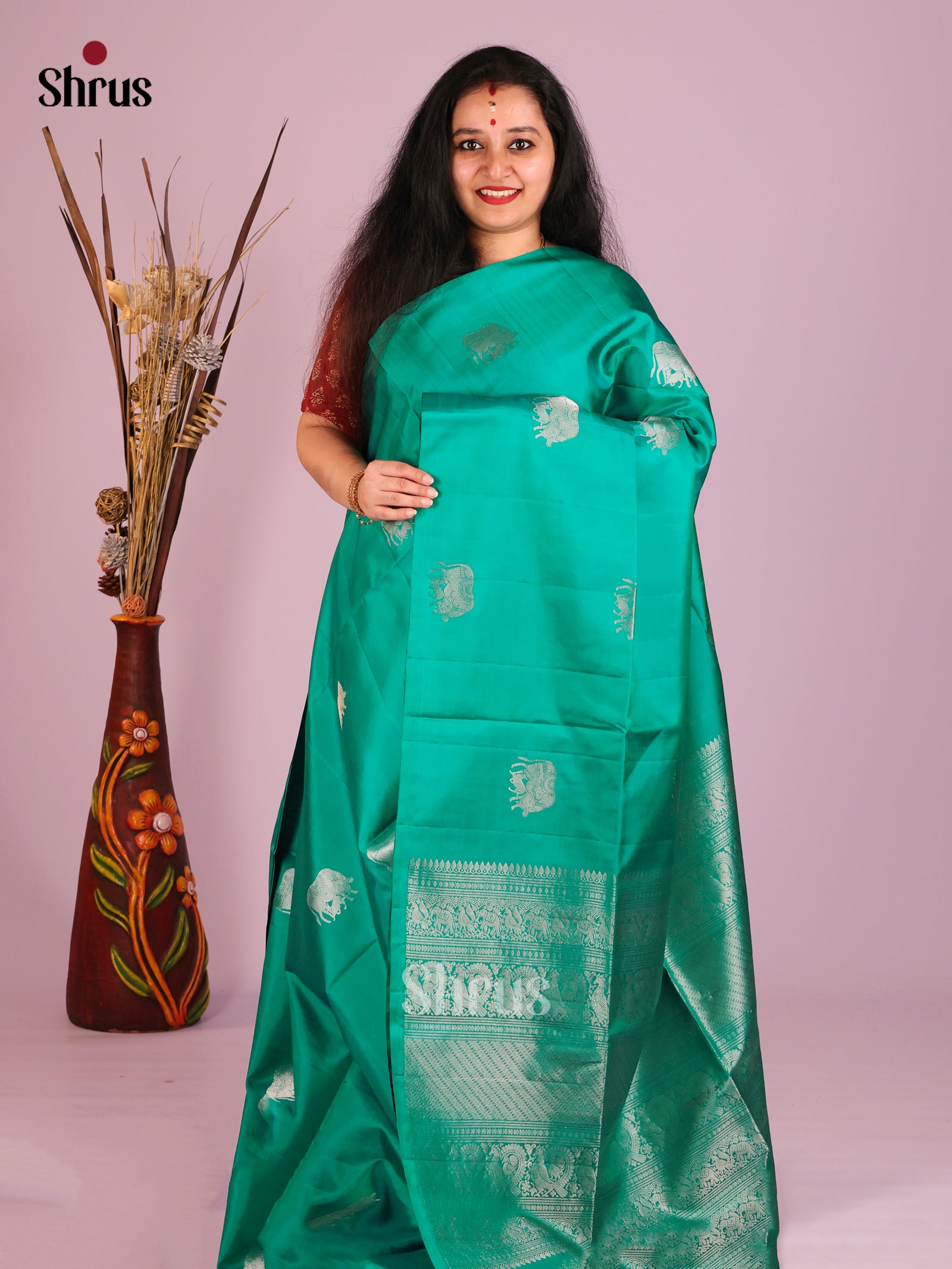 Serene Green Borderless Soft Silk Saree with zari cow buttas & Brocade Border