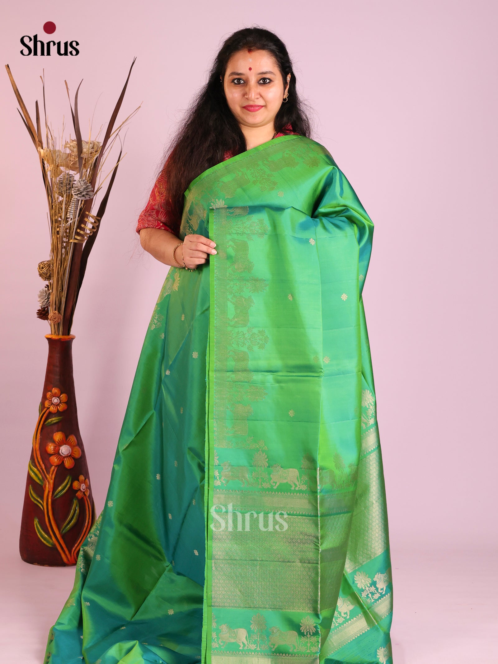 Festive Green Soft Silk Saree with gold Buttas & Zari Woven cow motifs in border