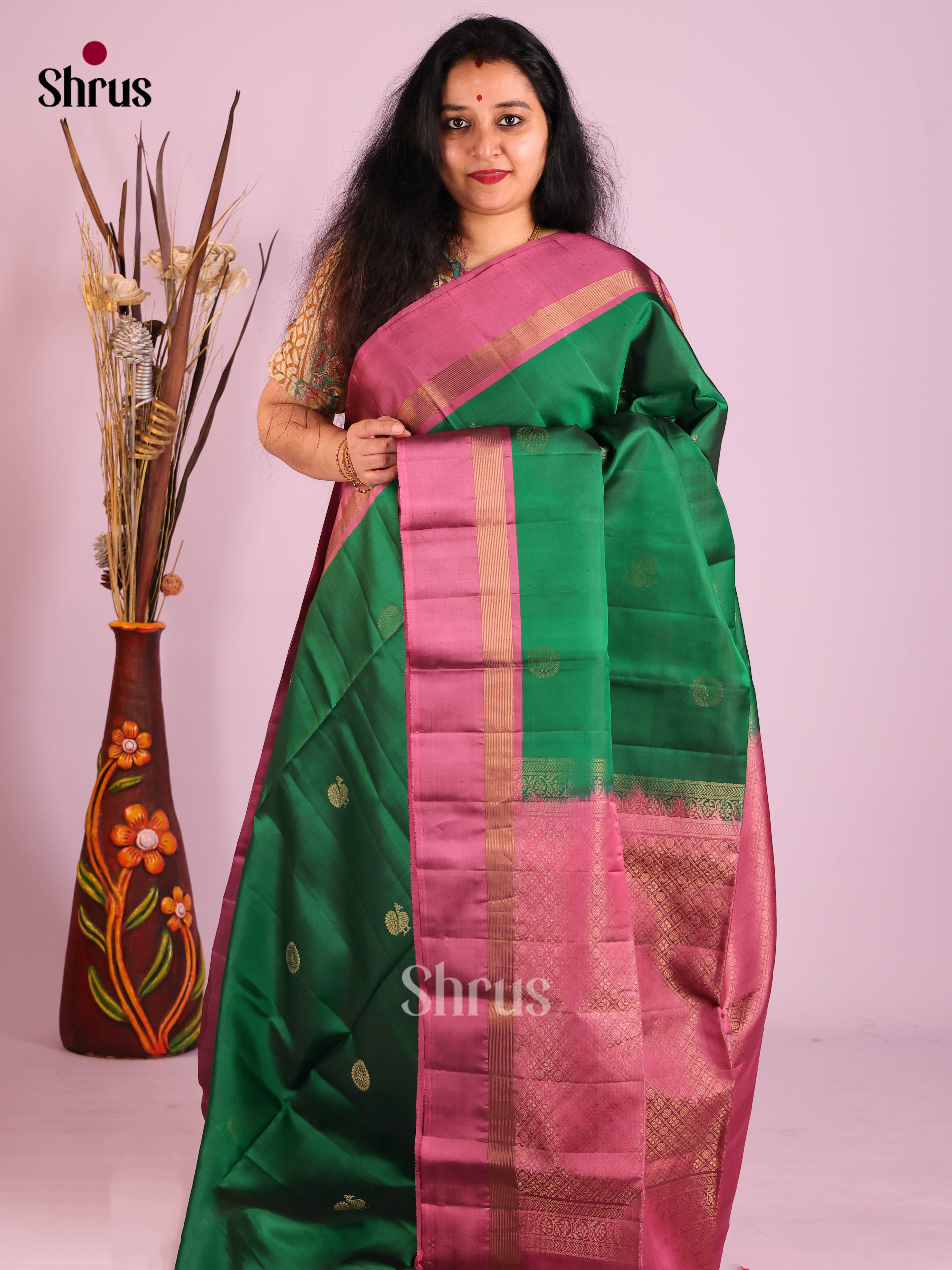 Exquisite Green Soft Silk Saree with gold zari peacock buttas & Purple Brocade Pallu 