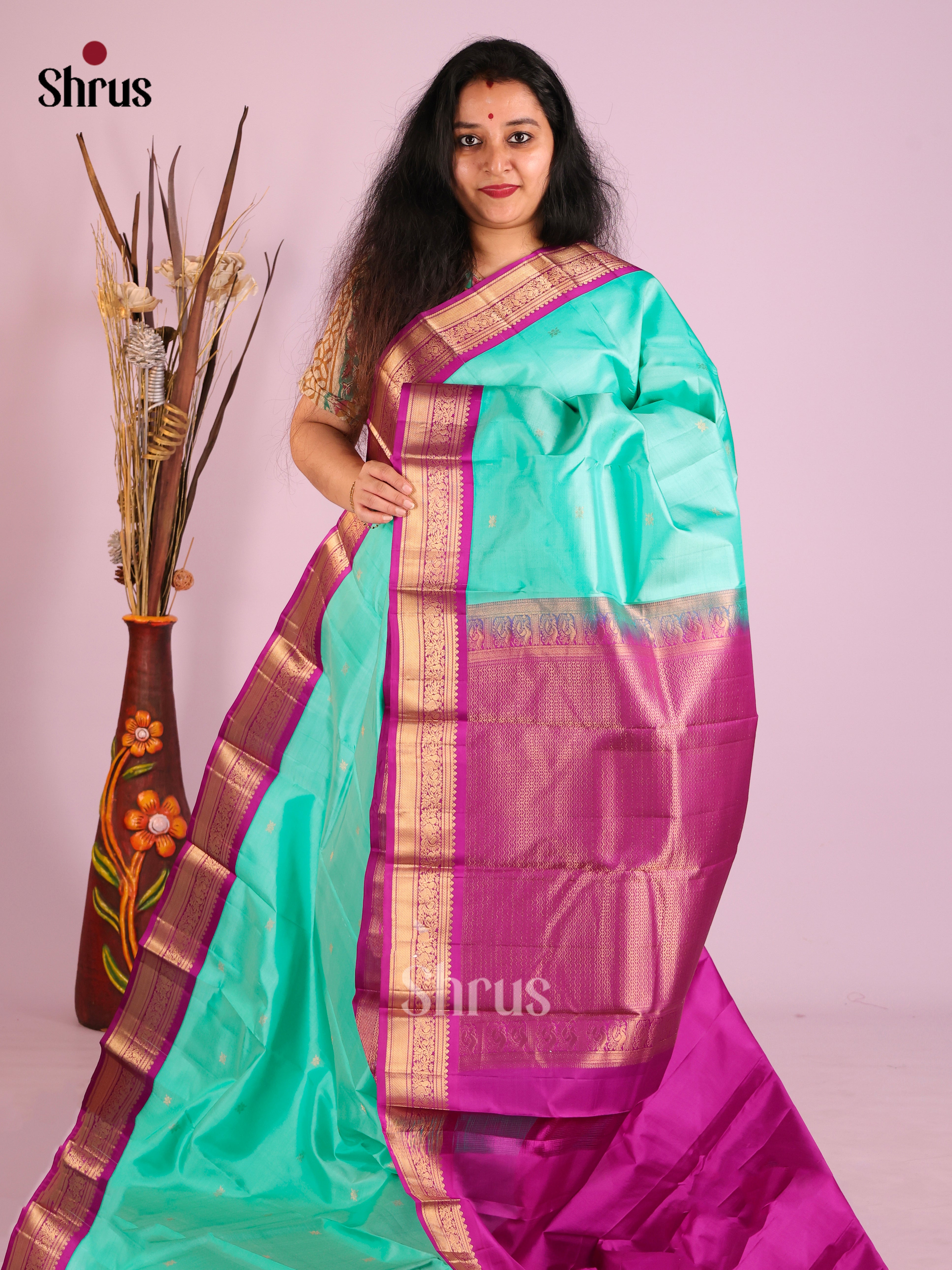 Opulent Teal Kanjivaram Saree with zari floral buttas & Purple Brocade Pallu