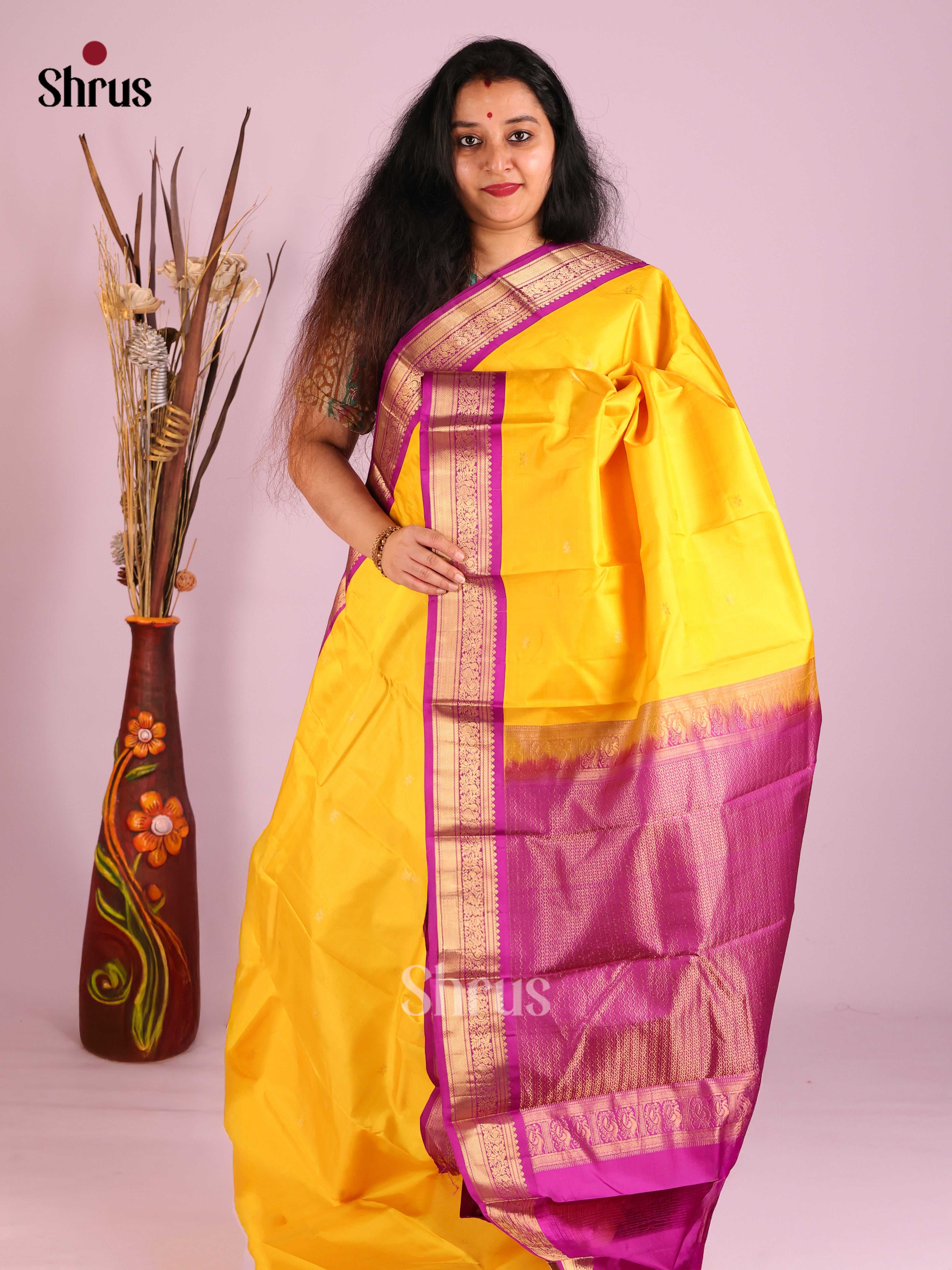 Luminous Yellow Kanjivaram Saree with golden buttas & Purple Brocade Pallu