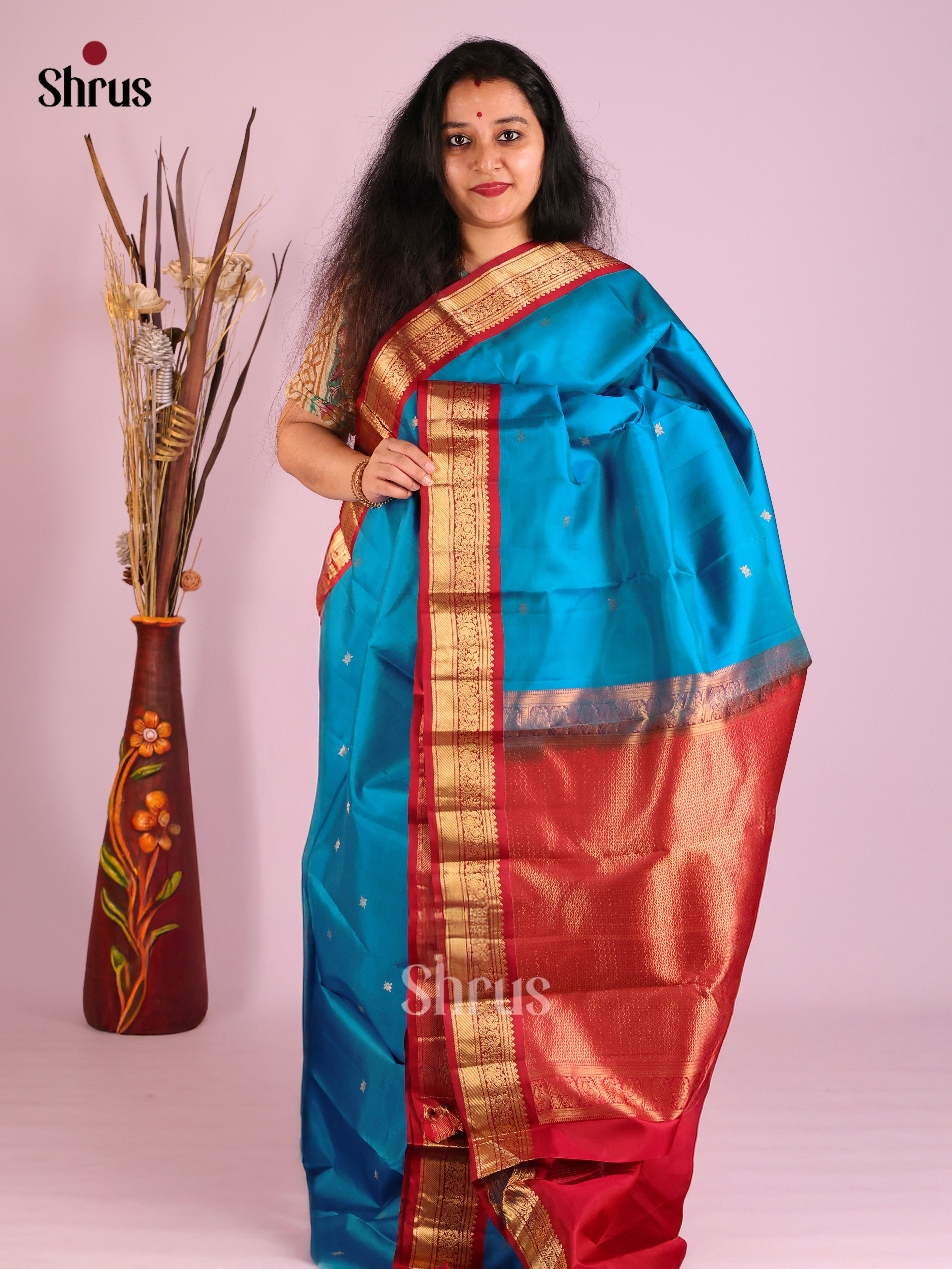 Serene Blue Kanjivaram Saree with golden floral buttas & Red Zari woven Border 