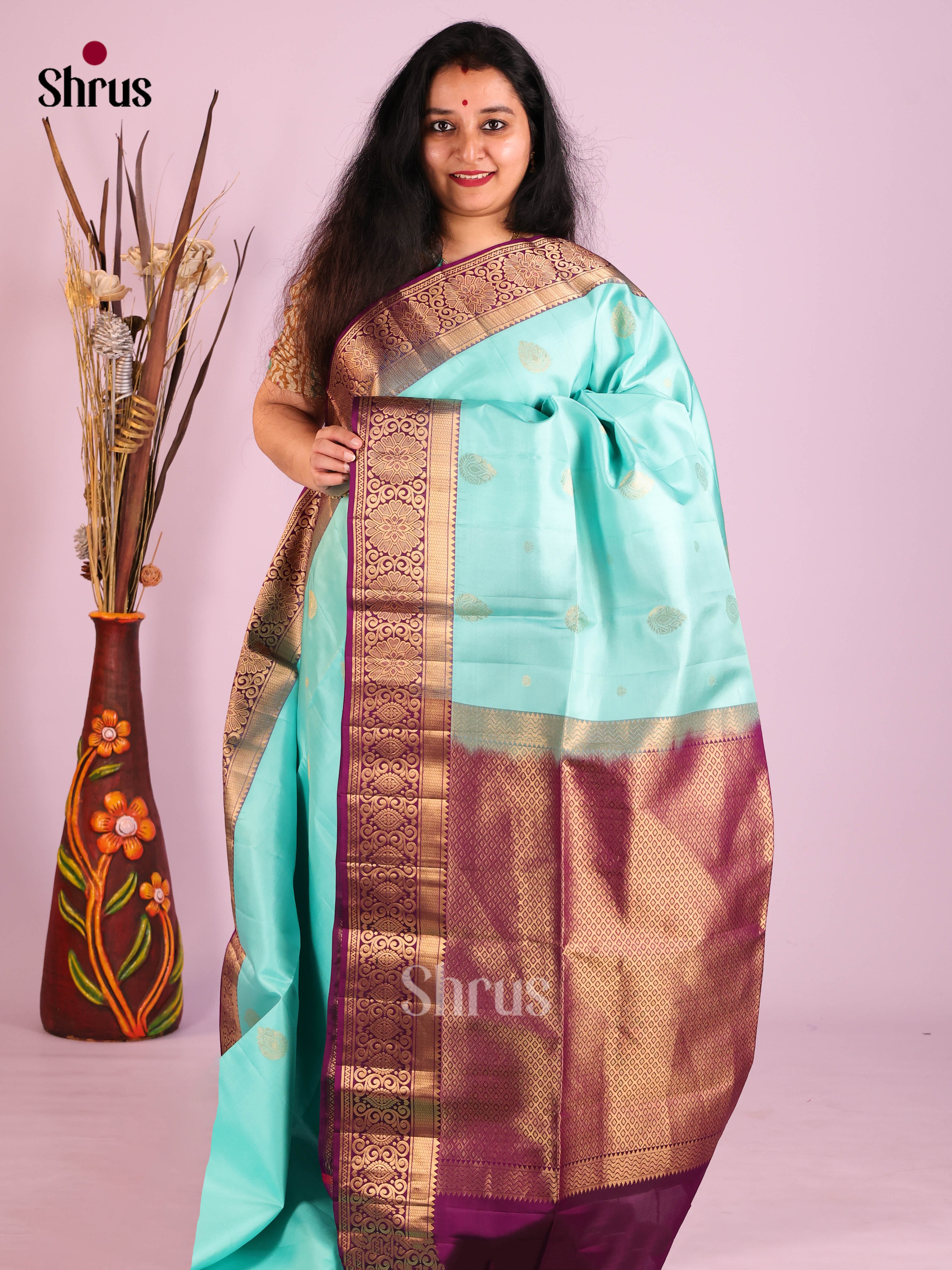 Exquisite Pastel blue Soft Silk Saree with gold floral buttas & Purple Brocade Pallu
