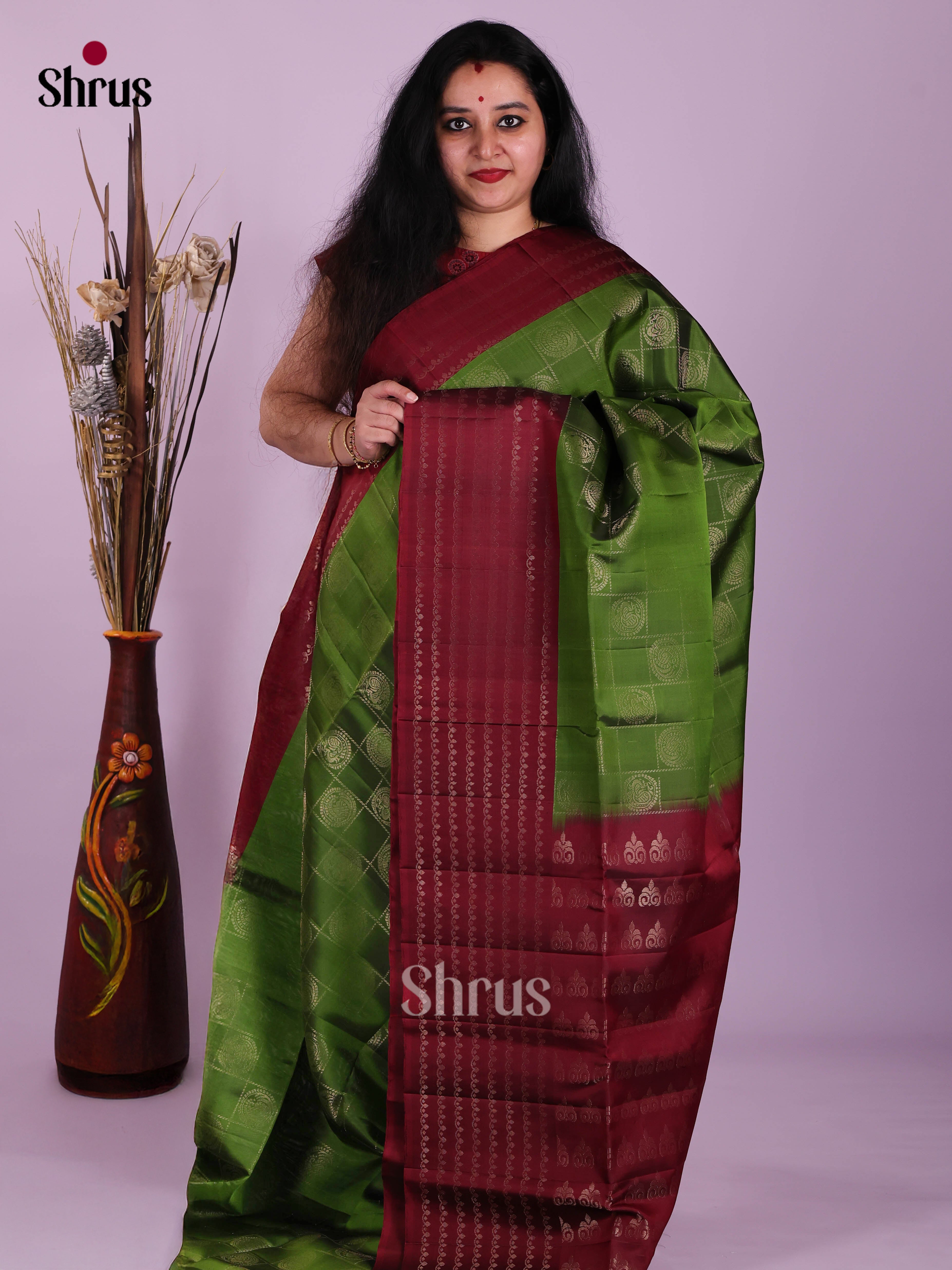Ethereal Green & Maroon  Soft Silk Saree dazzles with zari checks, peacock motifs - Shop on Shrus.com