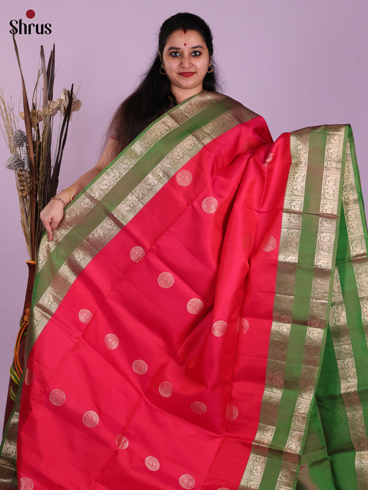 Chic Red & Green Soft Silk  Saree gleams with zari floral motifs , rettaipet border