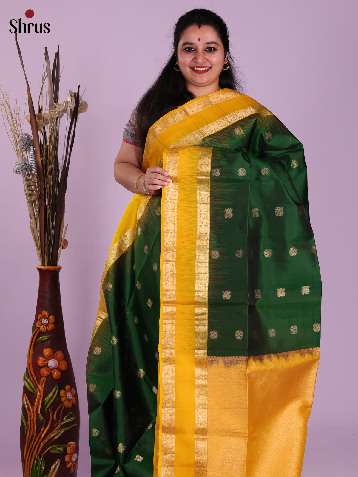 Contemporary Green & Yellow Soft Silk Saree gleams with gold zari peacock buttas