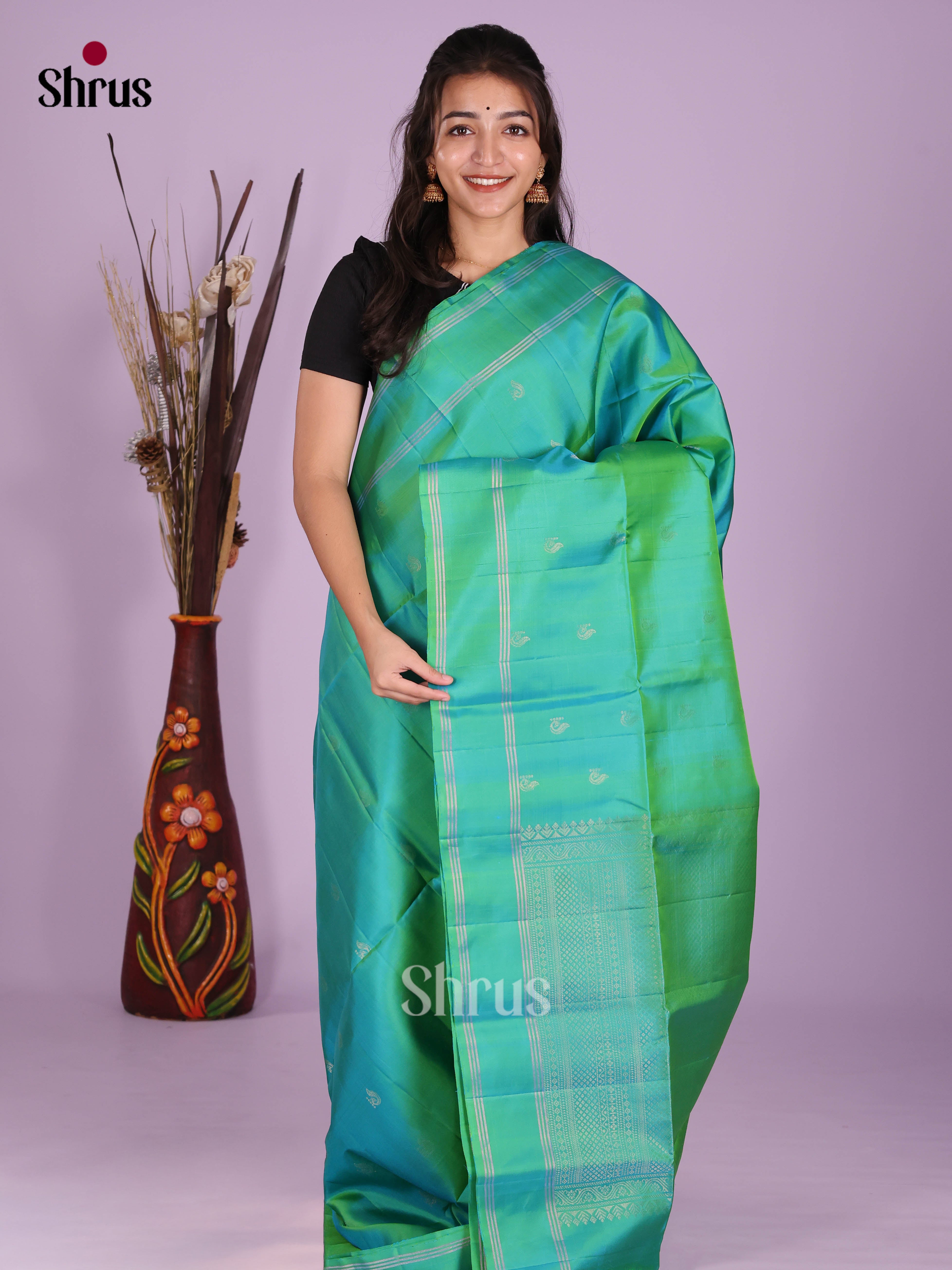 Enchanting Green single Tone Soft Silk Saree with zari buttas & rettaipet border