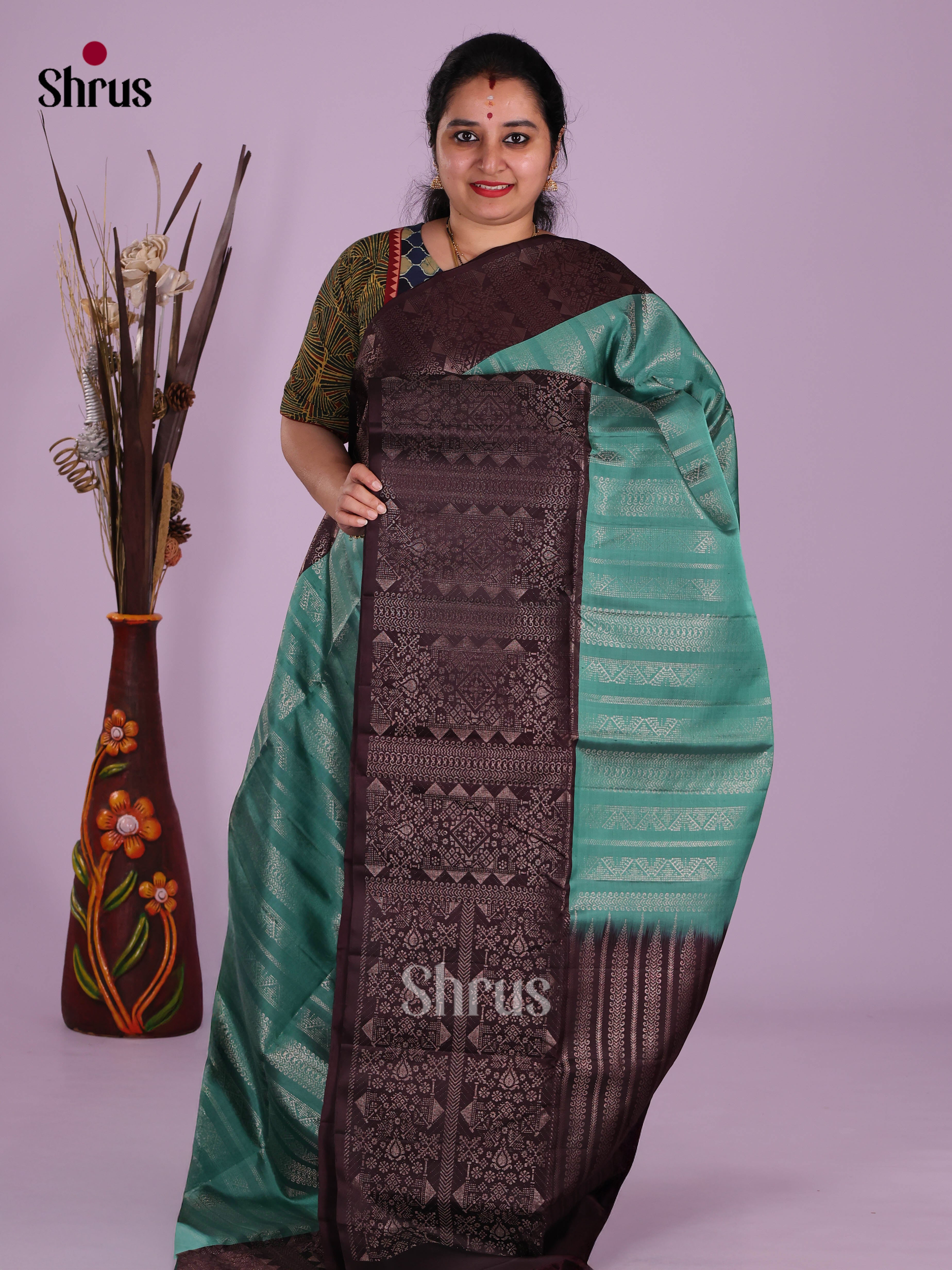 Sheeny Teal green Soft Silk Saree With Zari Stripes & Brown Brocade Border