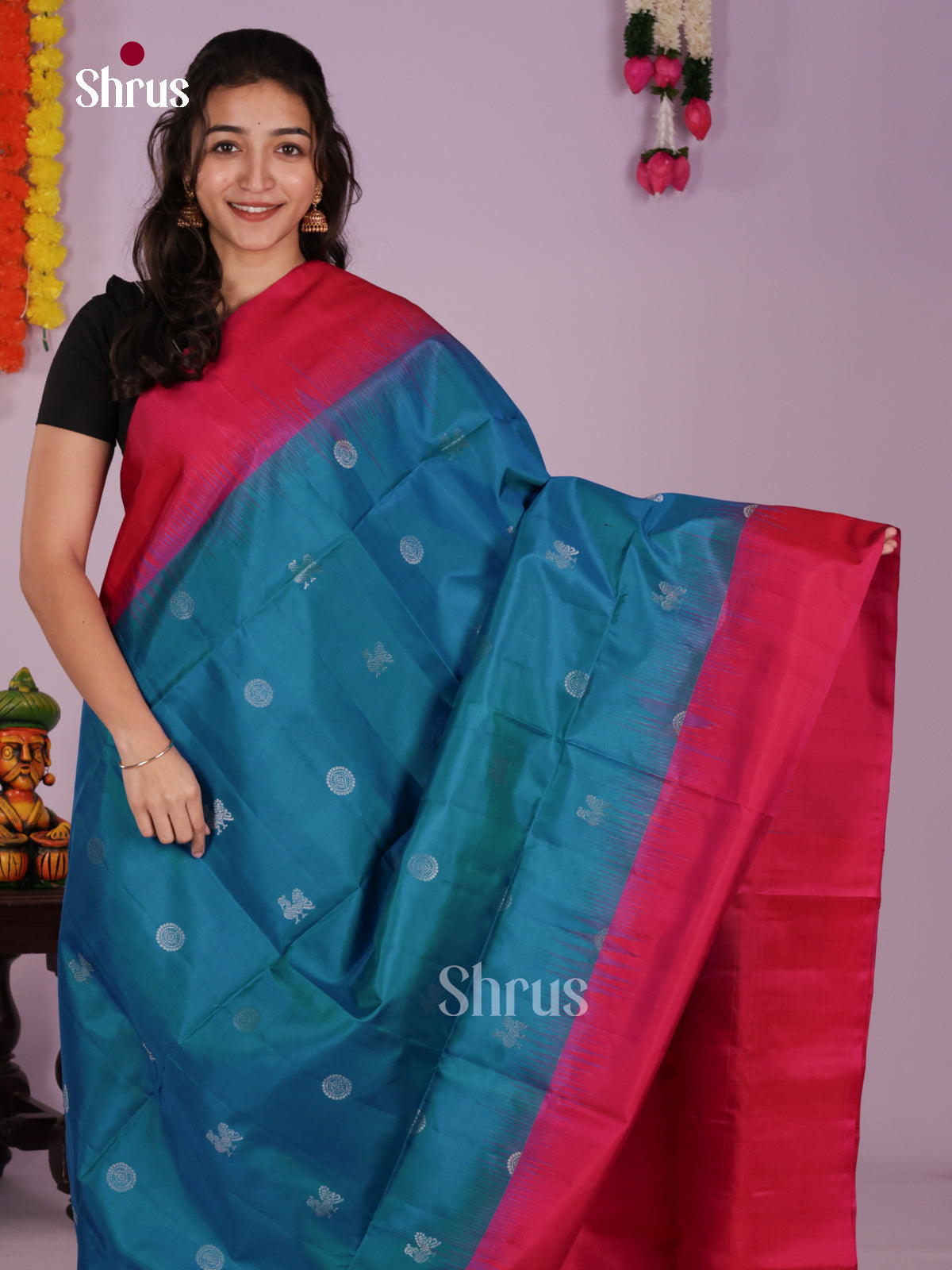 Exquisite Blue Soft Silk Saree gleams with zari peacock buttas & plain border