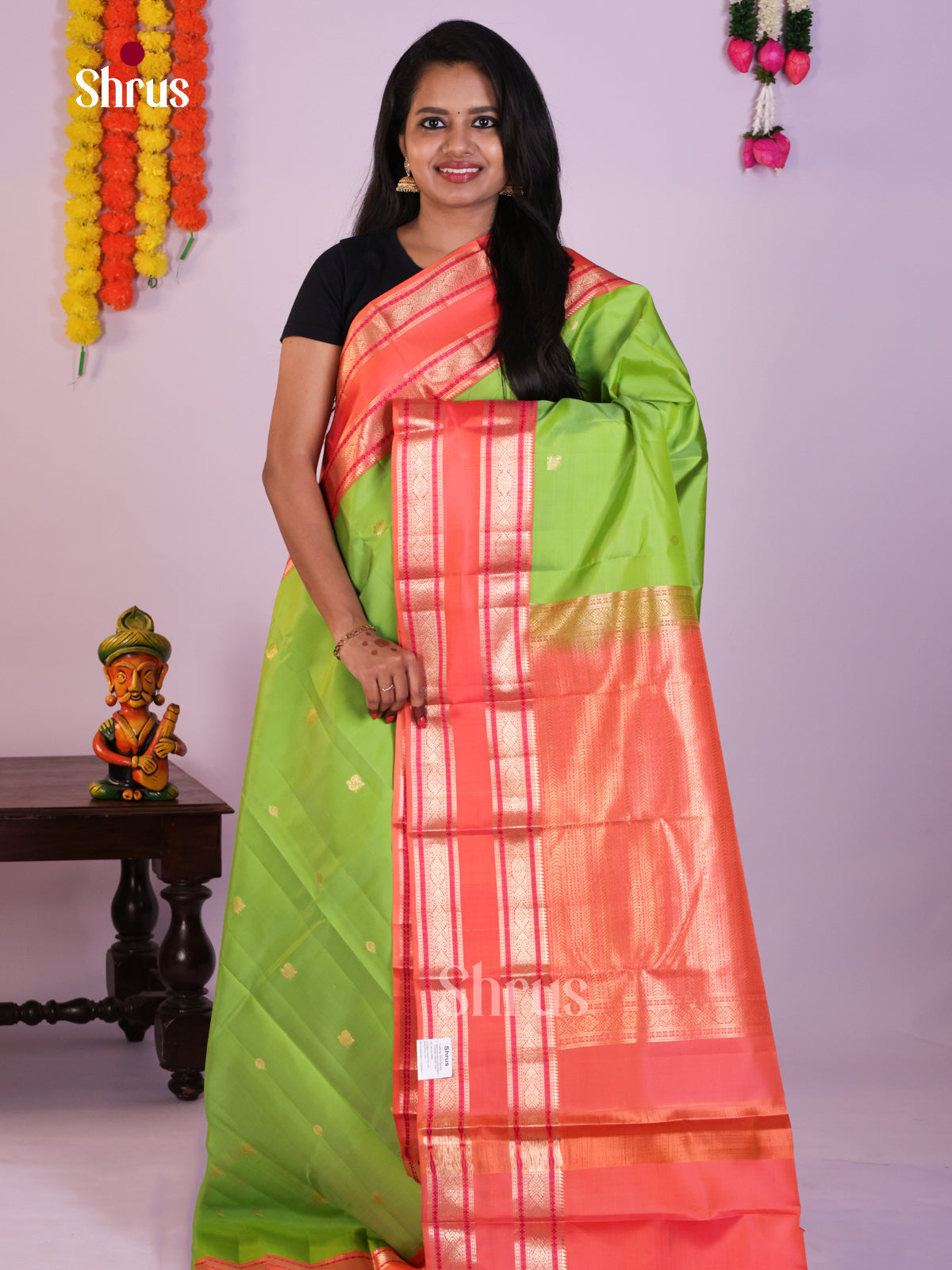 Green Kanjivaram Saree with Zari Buttas & Coral Rettaipet Border