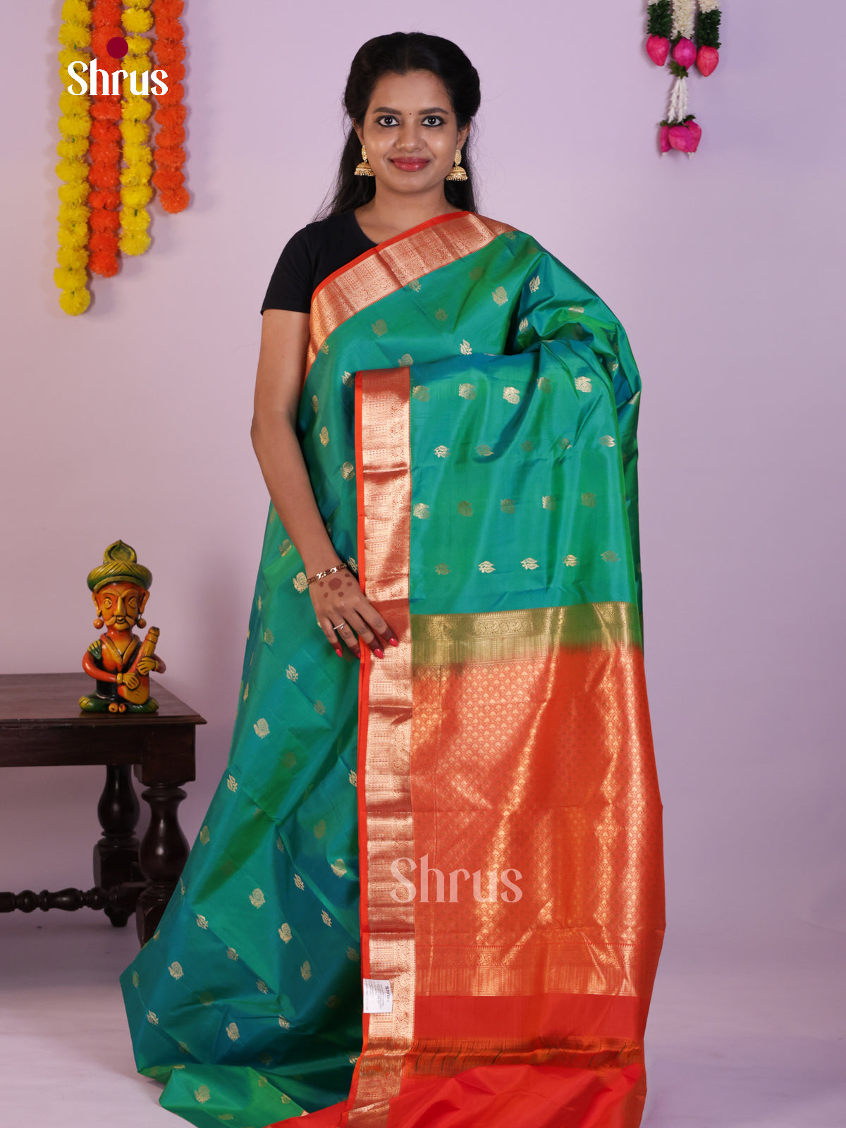 Classy Sea Green Kanjivaram Silk Saree With Peacock Buttas & Orange Zari Border