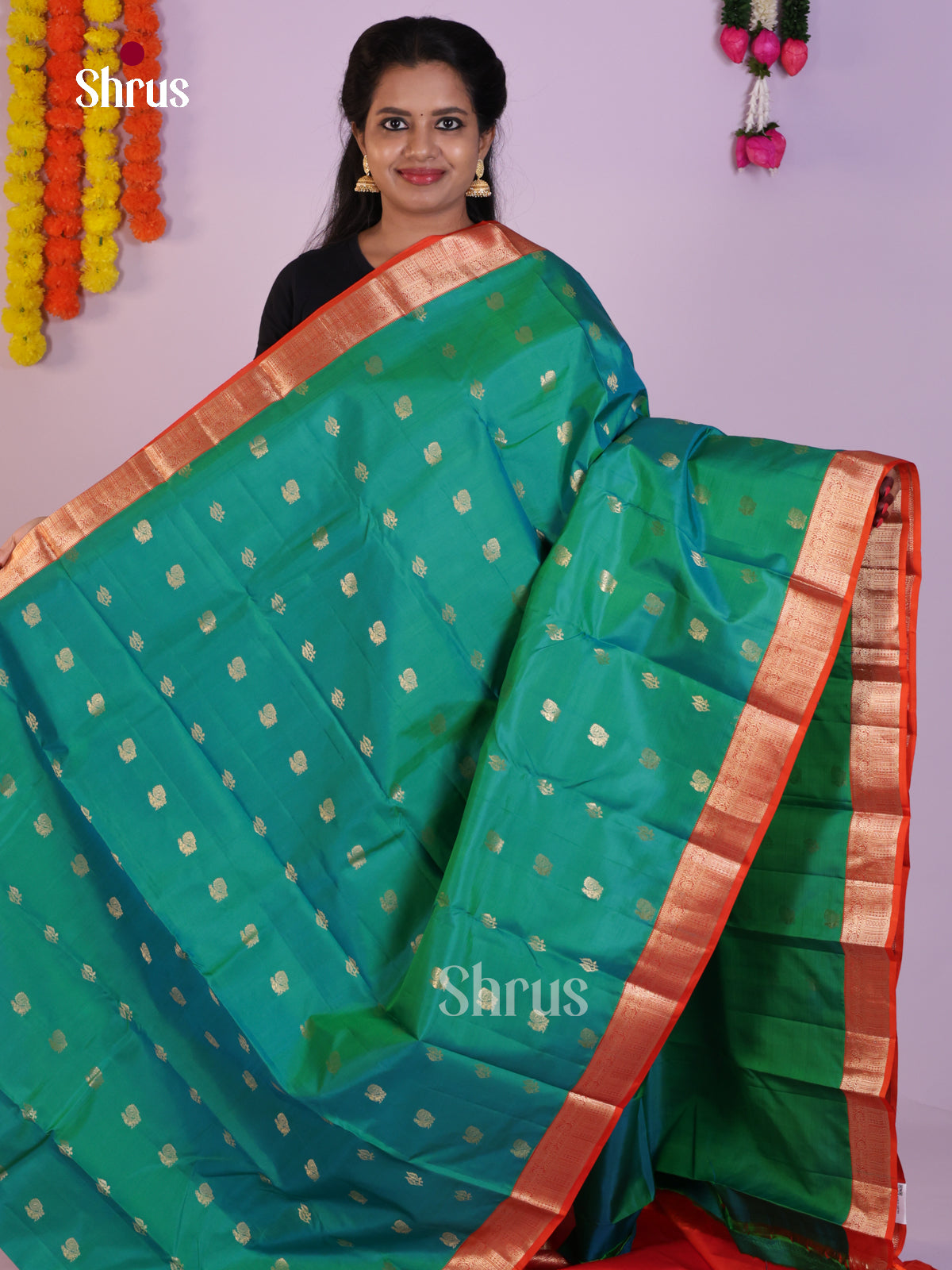 Classy Sea Green Kanjivaram Saree With Peacock Buttas & Orange Zari Border