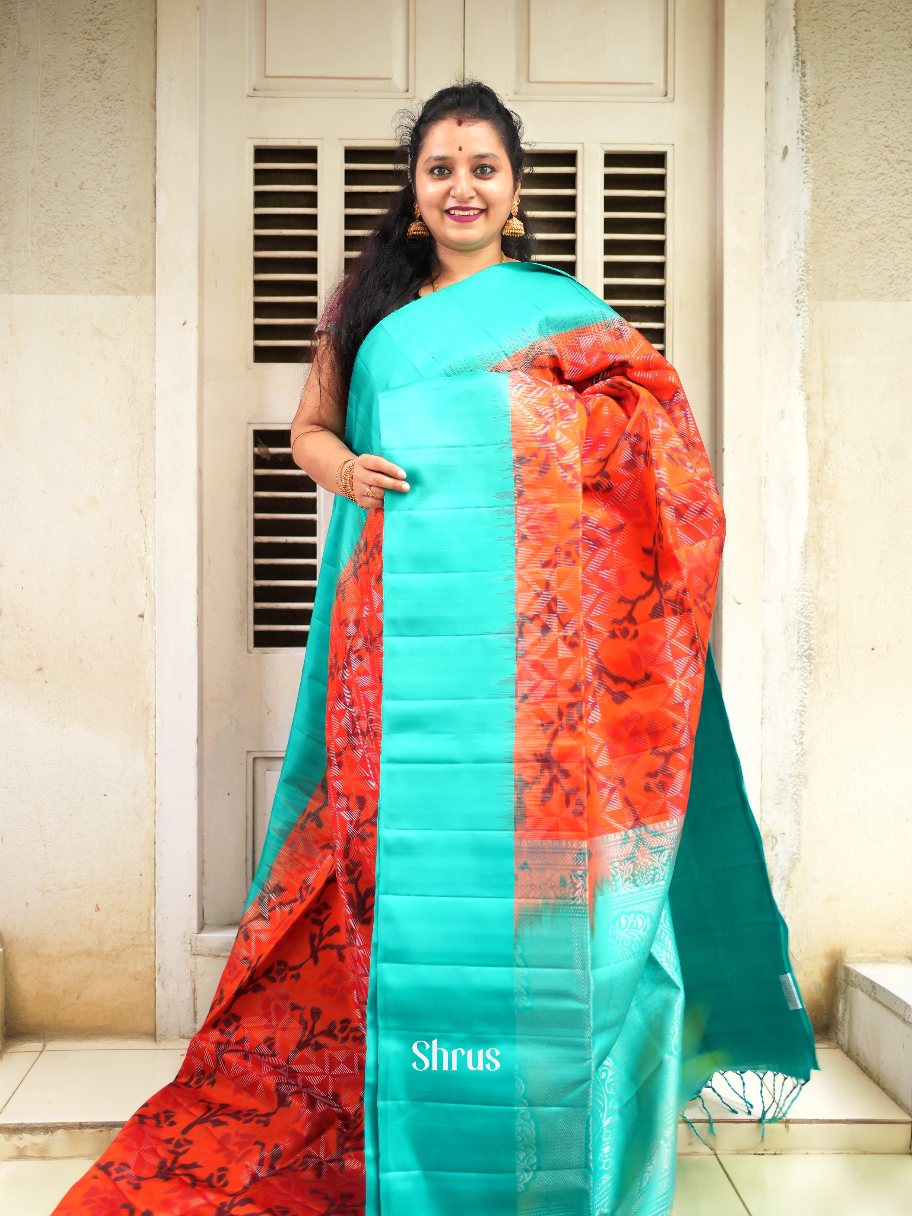 Vivid Orange Soft Silk Saree With Ikkat Floral Pattern, Teal Blue Border & Brocade Pallu